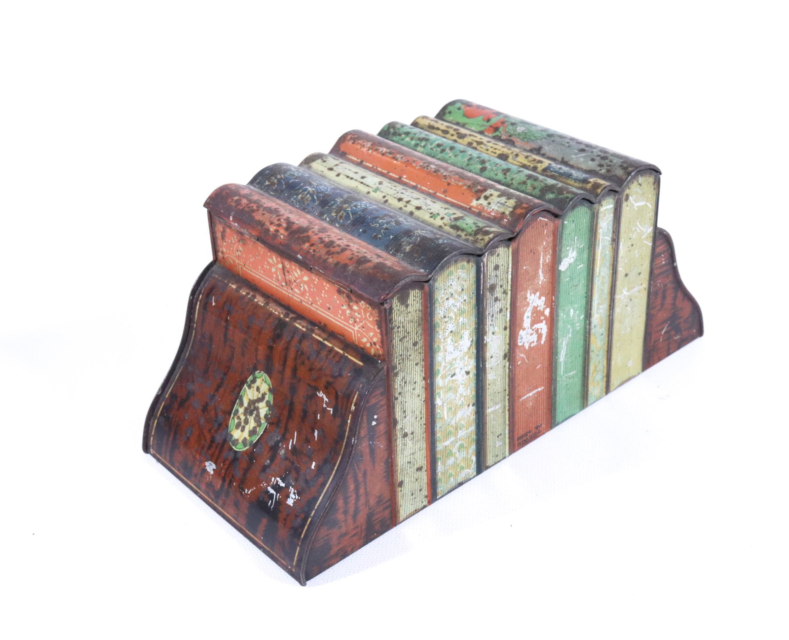 HUNTLEY & PALMERS TIN LITHO BISCUIT TIN: IN THE FORM OF SEVEN BOOKS BETWEEN FAUX BOOKENDS. CA. 1909 3 3/4" X 8 3/4" X 4"