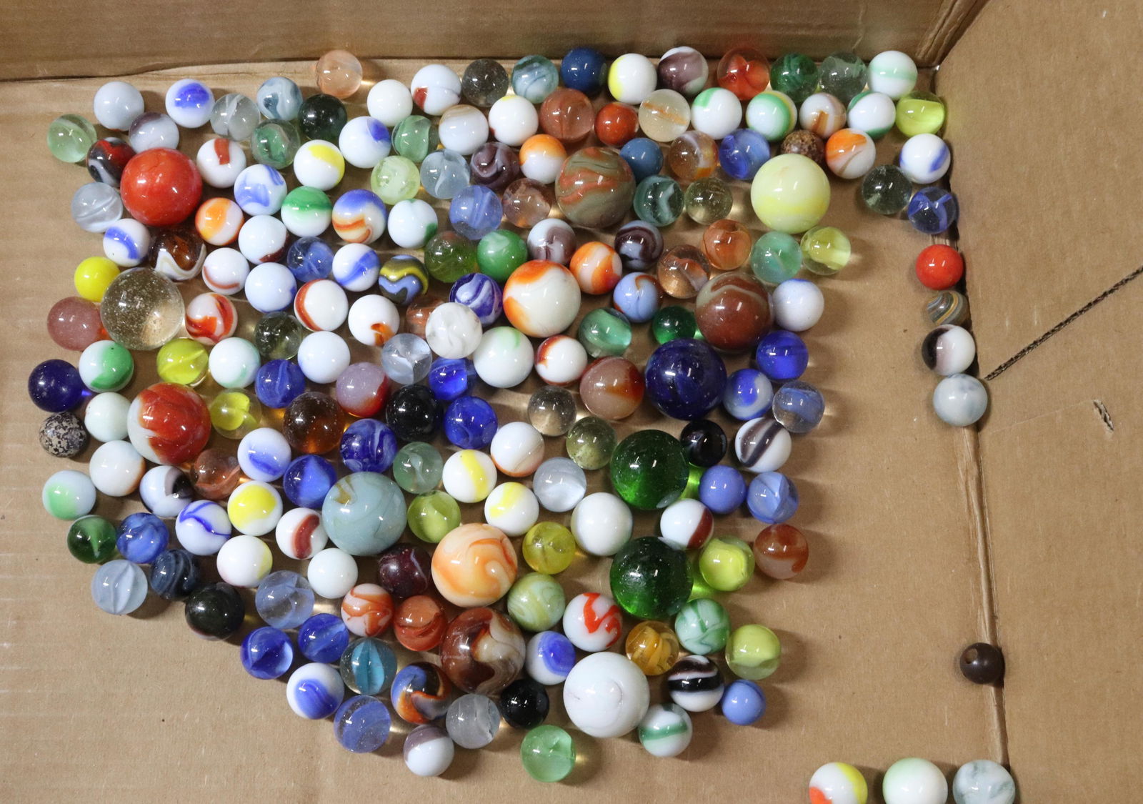 GROUP LOT OF GLASS MARBLES: SWIRL MARBLES IN VARIOUS SIZES Terms: Hartzell's Auction Gallery will handle most of the shipping in-house. WE do reserve the right to not ship some large items, larger lots of glassware, Furniture, o