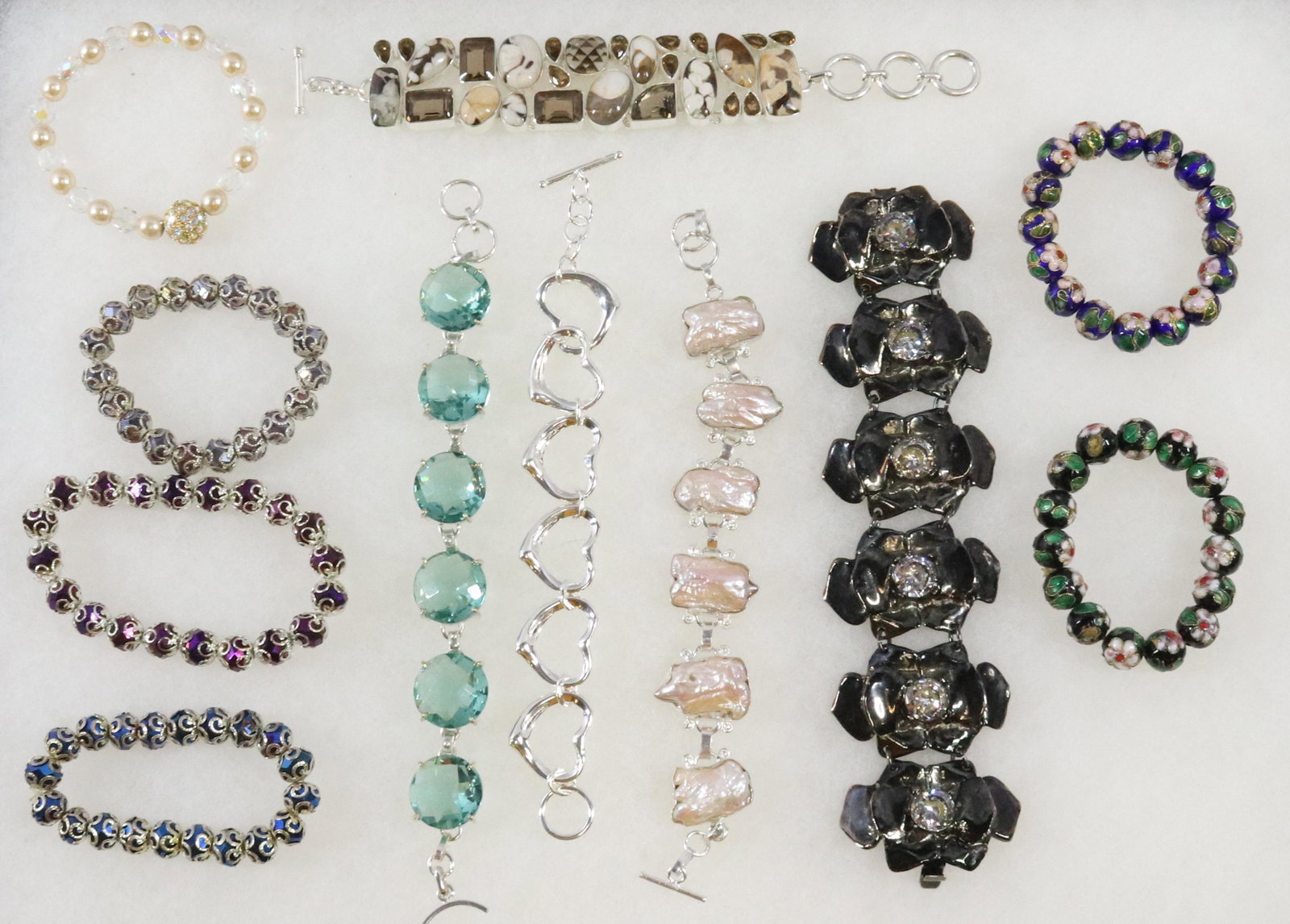LOT OF COSTUME JEWELRY BRACELETS: (11) VARIOUS STYLES Dimensions: LONGEST 8" Terms: Hartzell's Auction Gallery will handle most of the shipping in-house. WE do reserve the right to not ship some large items, larger lots of glassware, 