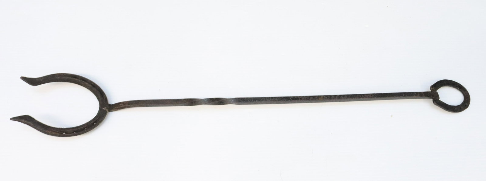 WROUGHT IRON HORSESHOE POKER: WROUGHT SHAFT WITH HORSESHOE ON EACH END DIMENSIONS: 37" H TERMS: Hartzell's Auction Gallery will handle most of the shipping in-house. WE do reserve the right to not ship some large items, larger lot