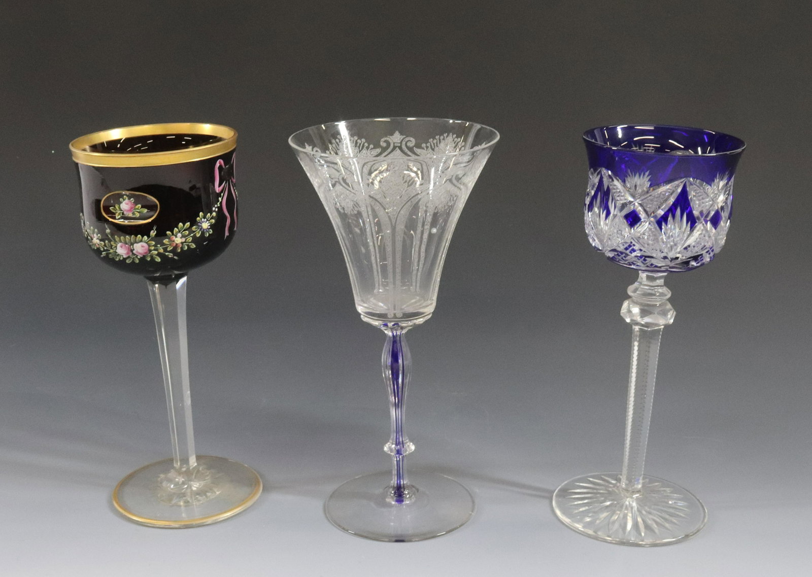 CUT OVERLAY 3 GOBLETS: COBALT CUT TO CLEAR, RUBY CUT TO CLEAR WITH ENAMELING ALSO COBALT STEM DIMENSIONS: 7 3/4" TERMS: Hartzell's Auction Gallery will handle most of the shipping in-house. WE do reserve the right to not sh