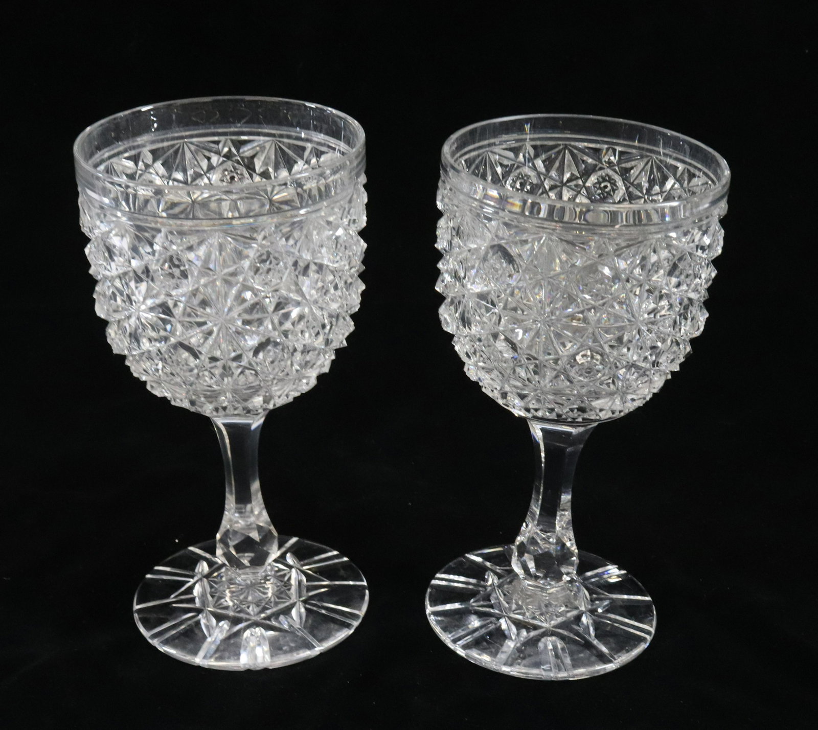 AMERICAN BRILLIANT CUT GOBLETS: (2) - RUSSIAN PATTERN OR DAISY & BUTTON PATTERN DIMENSIONS: 6 1/4" TERMS: Hartzell's Auction Gallery will handle most of the shipping in-house. WE do reserve the right to not ship some large items, la