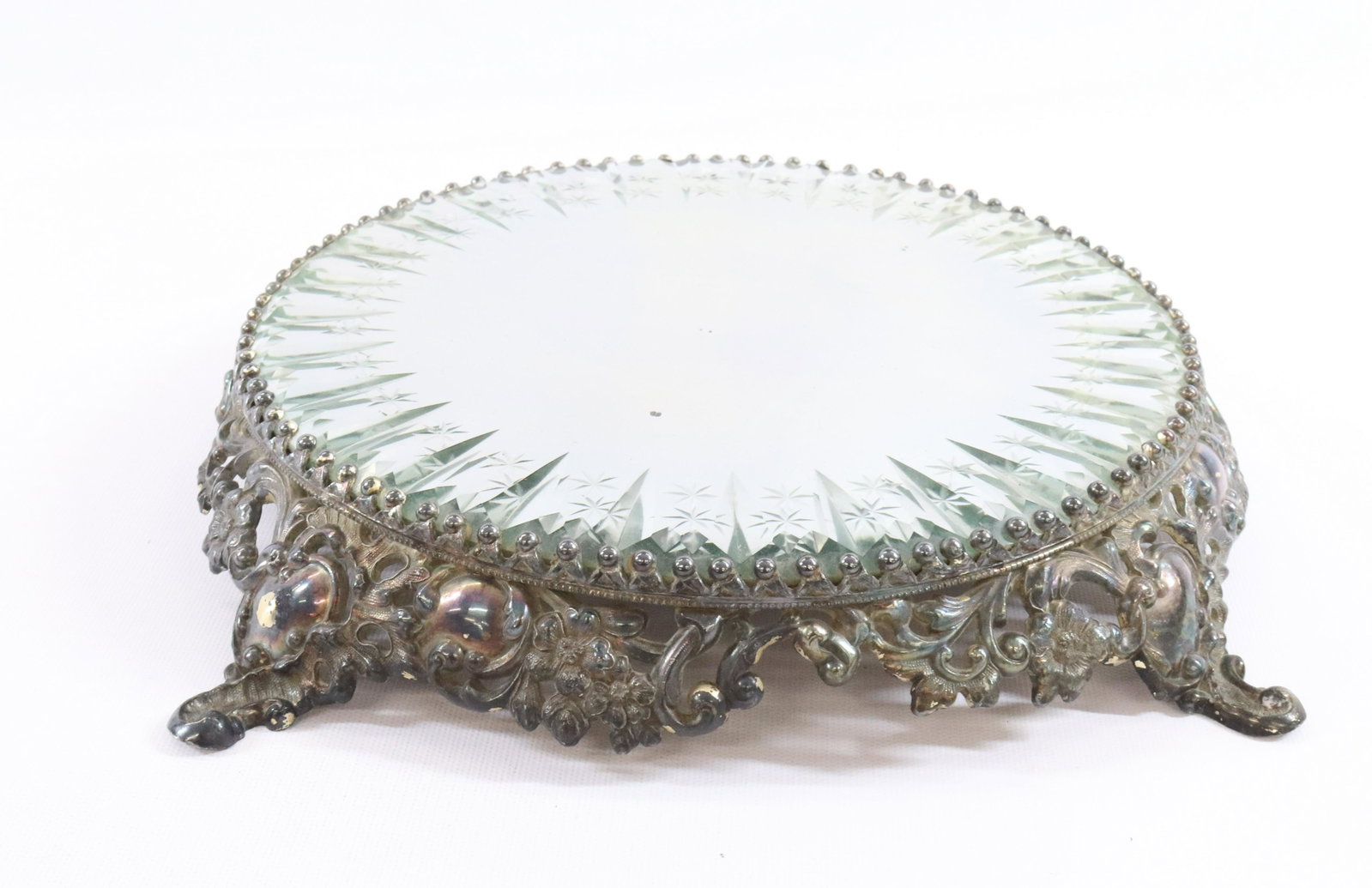 SILVER PLATE ORNATE ROUND PLATEAU: F.B.ROGERS SILVER CO. 1883 ORNATE CUT GLASS MIRROR ROCOCO FRAME DIMENSIONS: 2"H X 13 1/2" MIRROR 9 3/4"DIA TERMS: Hartzell's Auction Gallery will handle most of the shipping in-house. WE do reserve th