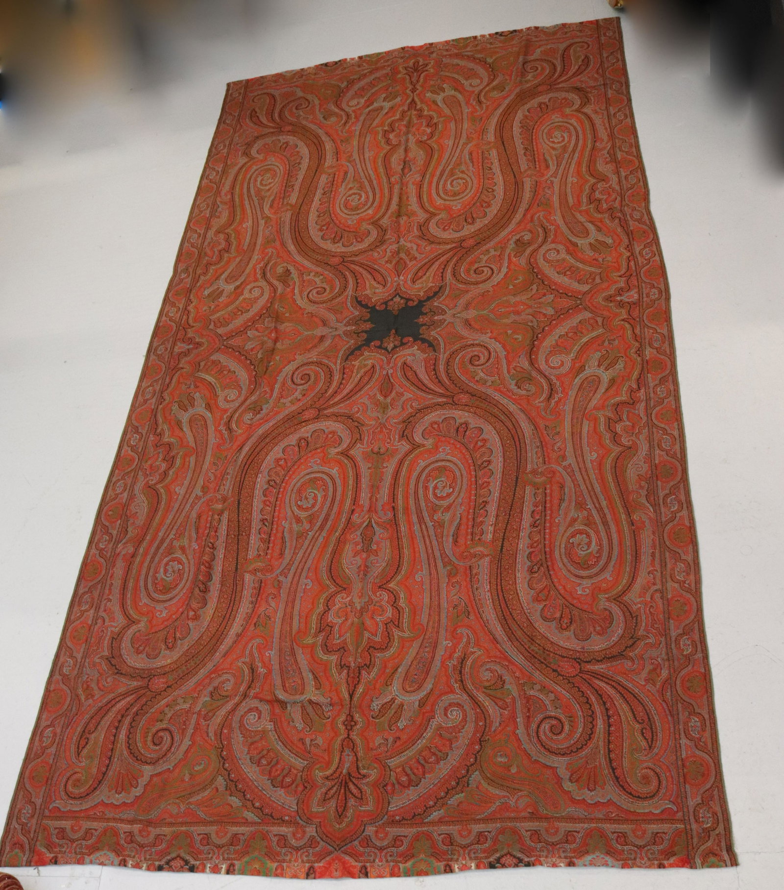 LARGE PAISLEY SHAW 19TH CENTURY: INTRICATE WOVEN DESIGN WITH SMALL BLACK CENTER DIMENSIONS: 114" X 58" TERMS: Hartzell's Auction Gallery will handle most of the shipping in-house. WE do reserve the right to not ship some large items,