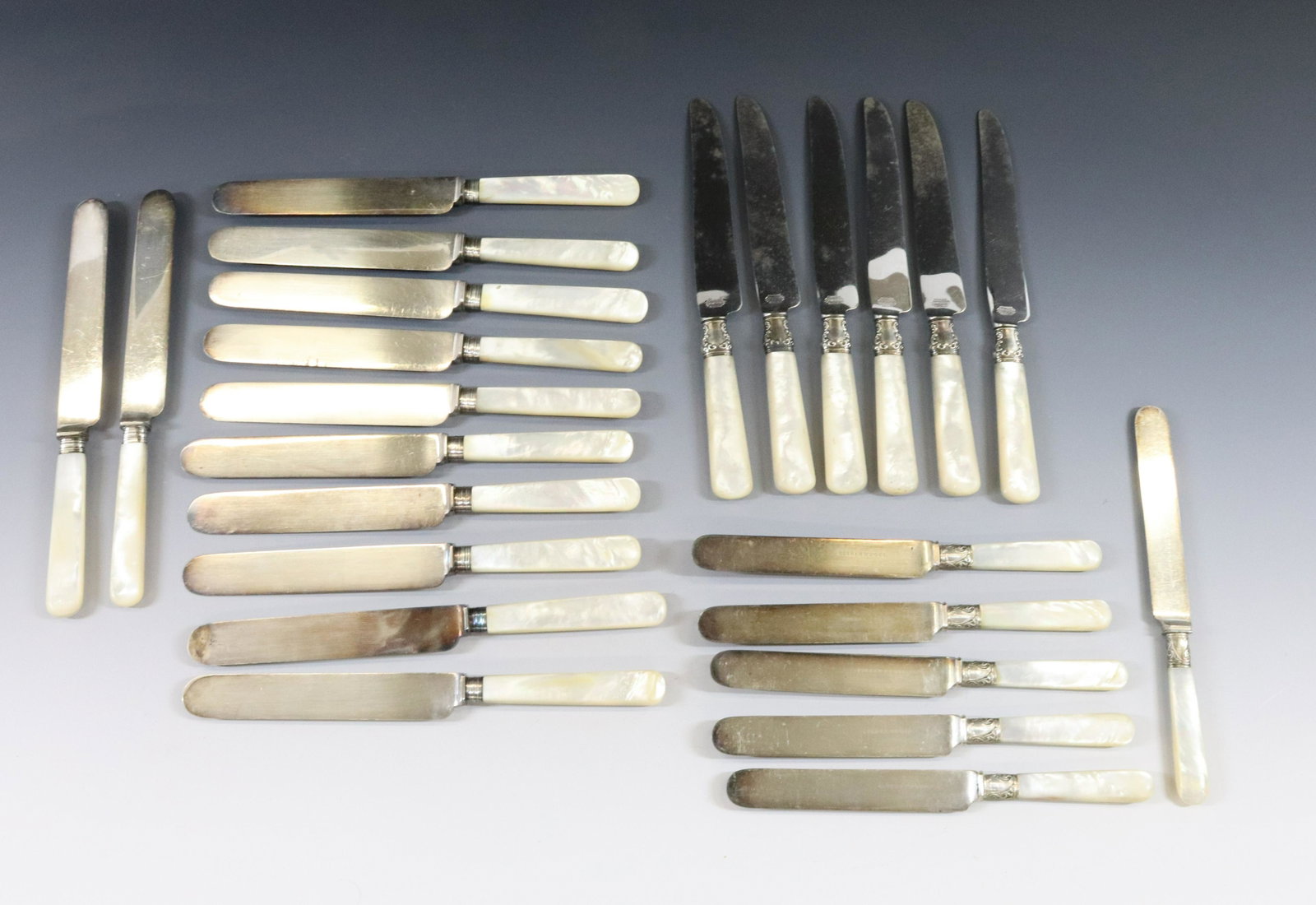 SILVER PLATE AND MOTHER OF PEARL FLATWARE: (24) KNIVES 12 MATCHING, 6 MATCHING, 6 MATCHING 12 WITH STERLING BANDS 12 UNMARKED DIMENSIONS: 8" TO 9" TERMS: Hartzell's Auction Gallery will handle most of the shipping in-house. WE do reserve the r