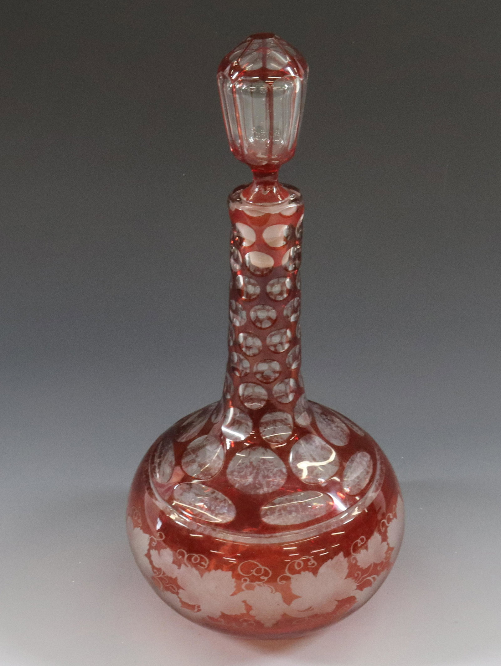 CZECH CUT AND ENGRAVED GLASS DECANTER: WITH ORIGINAL STOPPER VINTAGE GRAPE GARLAND ENGRAVING DIMENSIONS: 12 1/2" TERMS: Hartzell's Auction Gallery will handle most of the shipping in-house. WE do reserve the right to not ship some large it