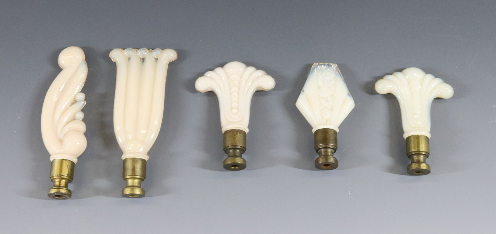 ALADDIN ALACITE LAMP FINIAL GROUP: (5) ITEMS FOUR DIFFERENT PATTERNS TWO MATCHING DIMENSIONS: 2 3/4" TO 4" TERMS: Hartzell's Auction Gallery will handle most of the shipping in-house. WE do reserve the right to not ship some large item