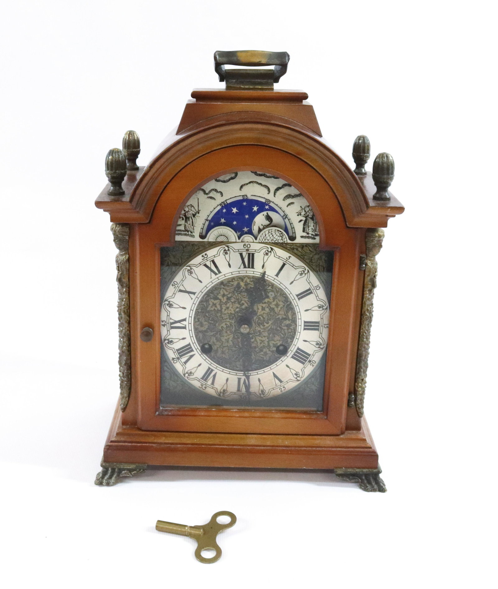 VINTAGE WOOD CASE CLOCK: W. HAID MFG WEST GERMANY WITH ALARM SUN AND MOON DIAL BRASS METAL MOUNTS ORIGINAL KEY DIMENSIONS: 10 1/2"H X 7 1/2 X 4 3/4" TERMS: Hartzell's Auction Gallery will handle most of the shipping in-house.