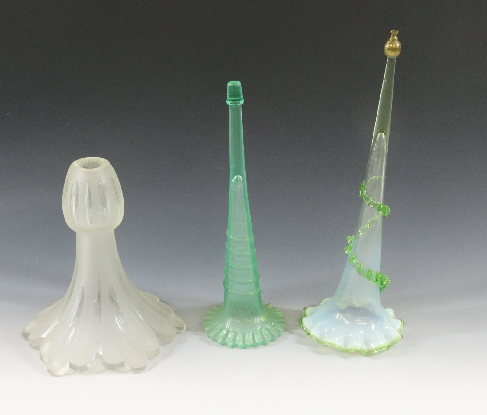 EPERGNE VASES: (3) FROSTED CUT TO CLEAR VASE, BLOWN GREEN OPAL WITH GREEN BAND AND PRESSED GLASS VASE DIMENSIONS: 9 1/4"H 14 3/4", 12 1/2" TERMS: Hartzell's Auction Gallery will handle most of the shipping in-house.