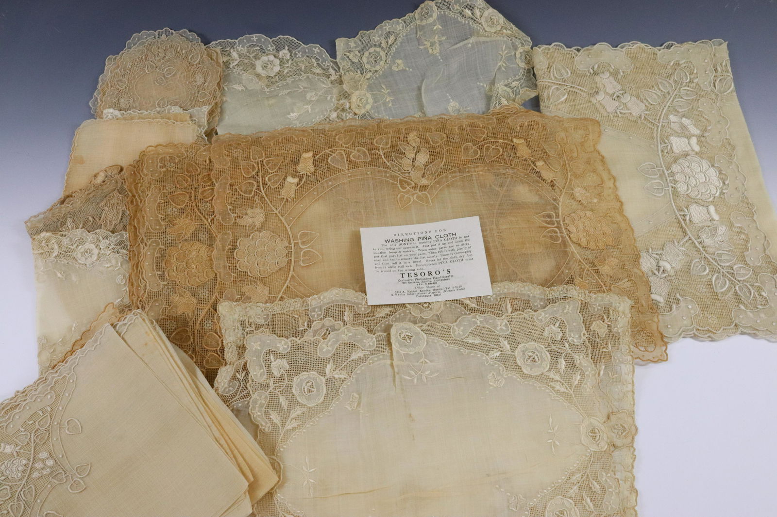 DINING ROOM LINENS GROUPING: PINA LACE DOILIES NAPKINS PLACEMATS AND TABLE RUNNER 42 PIECES TOTAL INCLUDES 12 PLACE MATS ETC. MANILA PHILIPPINES DIMENSIONS: PLACE MAT 12" X 18" TERMS: Hartzell's Auction Gallery will handle most o