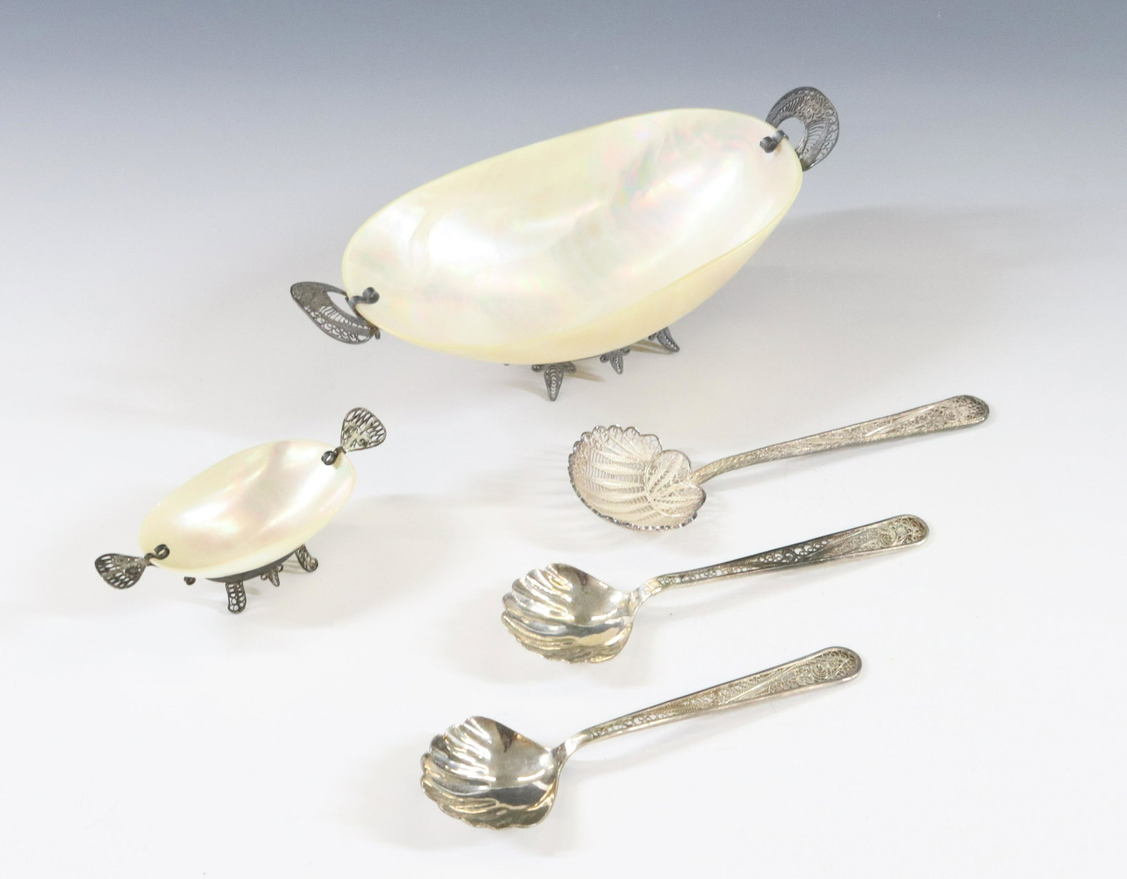 STERLING SILVER AND MOTHER OF PEARL GROUP: CARVED SHELL BOWL AND SALT BOWL WITH SILVER FILIGREE MOUNTS THREE SERVING SPOONS ONE WITH FINE FILIGREE BOWL SILVER 950 OR HIGHER UNMARKED 1.58 OZT PLUS SILVER MOUNTS ON BOWLS DIMENSIONS: 2 1/4"H X 7"