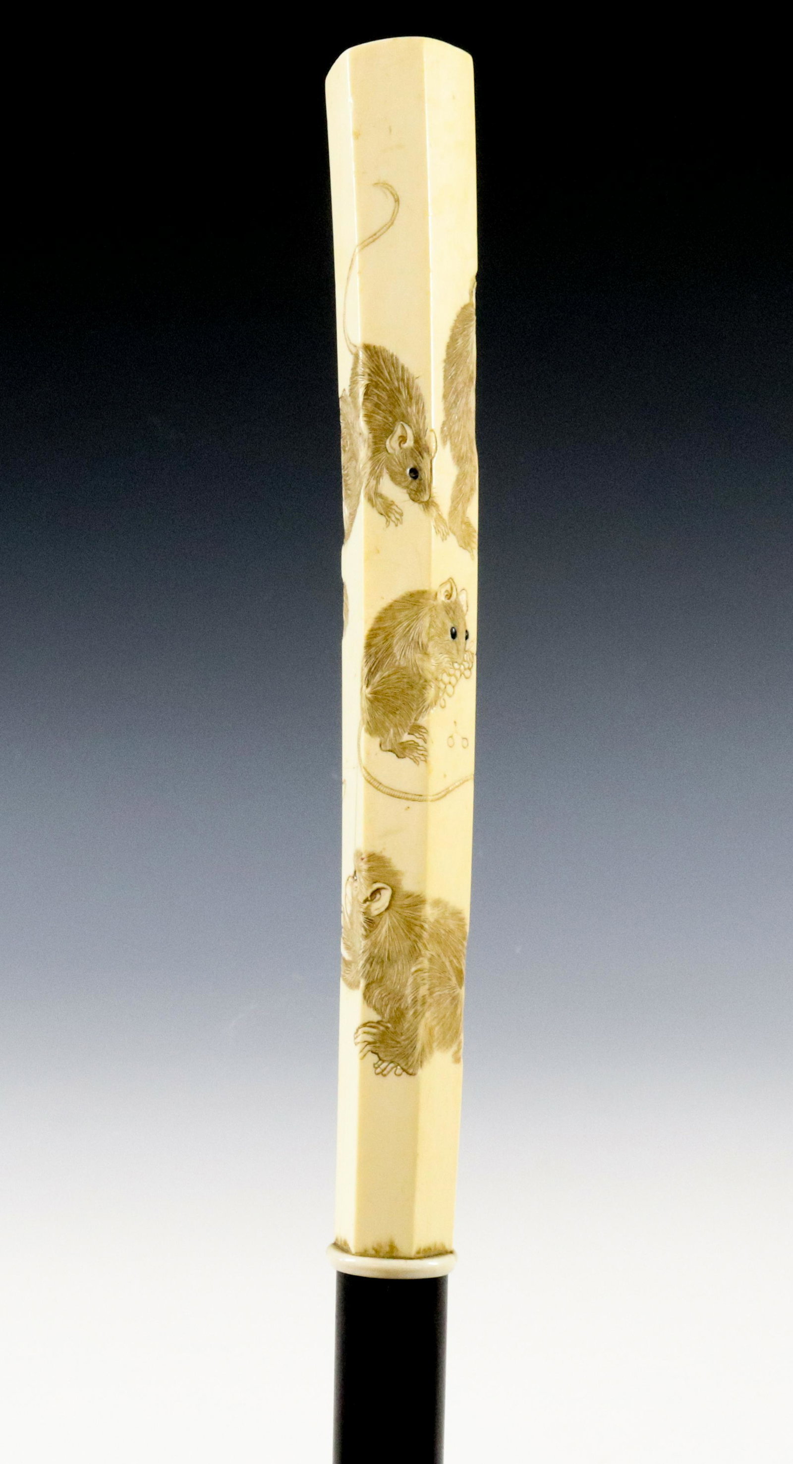 19TH C. CARVED BONE HANDLED ENGLISH CANE: HEXAGONAL SHAPED HANDLE WITH ENGRAVED FAMILY OF THREE MONKEYS AND THREE RATS. JAPANESE EXPORT HANDLE ON EBONY SHAFT WITH TURNED BONE COLLAR AND BRONZE FERRULE. MEIJI PERIOD 1880S DIMENSIONS: 39 1/4" L