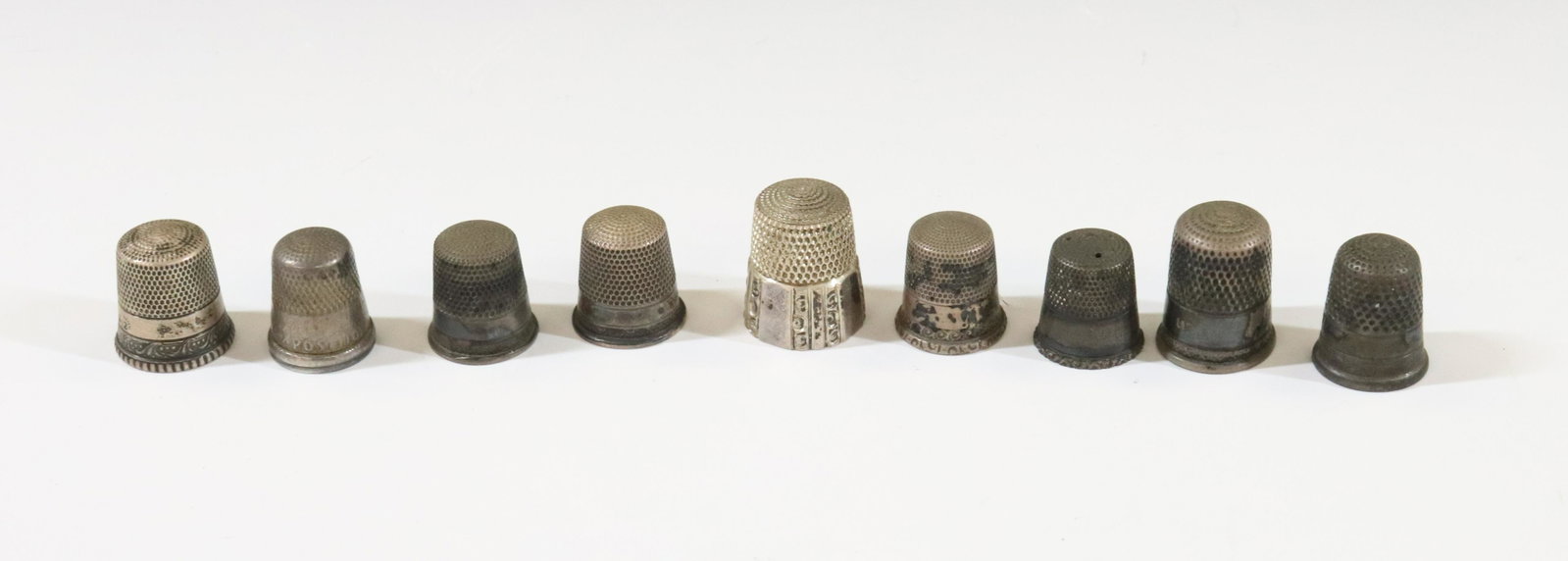 STERLING SILVER THIMBLES: (9) INCLUDING ONE WITH SCENIC BORDER, 1893 COLUMBIAN EXPOSITION ETC TOTAL WEIGHT 1.16 OZT TERMS: Hartzell's Auction Gallery will handle most of the shipping in-house. WE do reserve the right to not sh