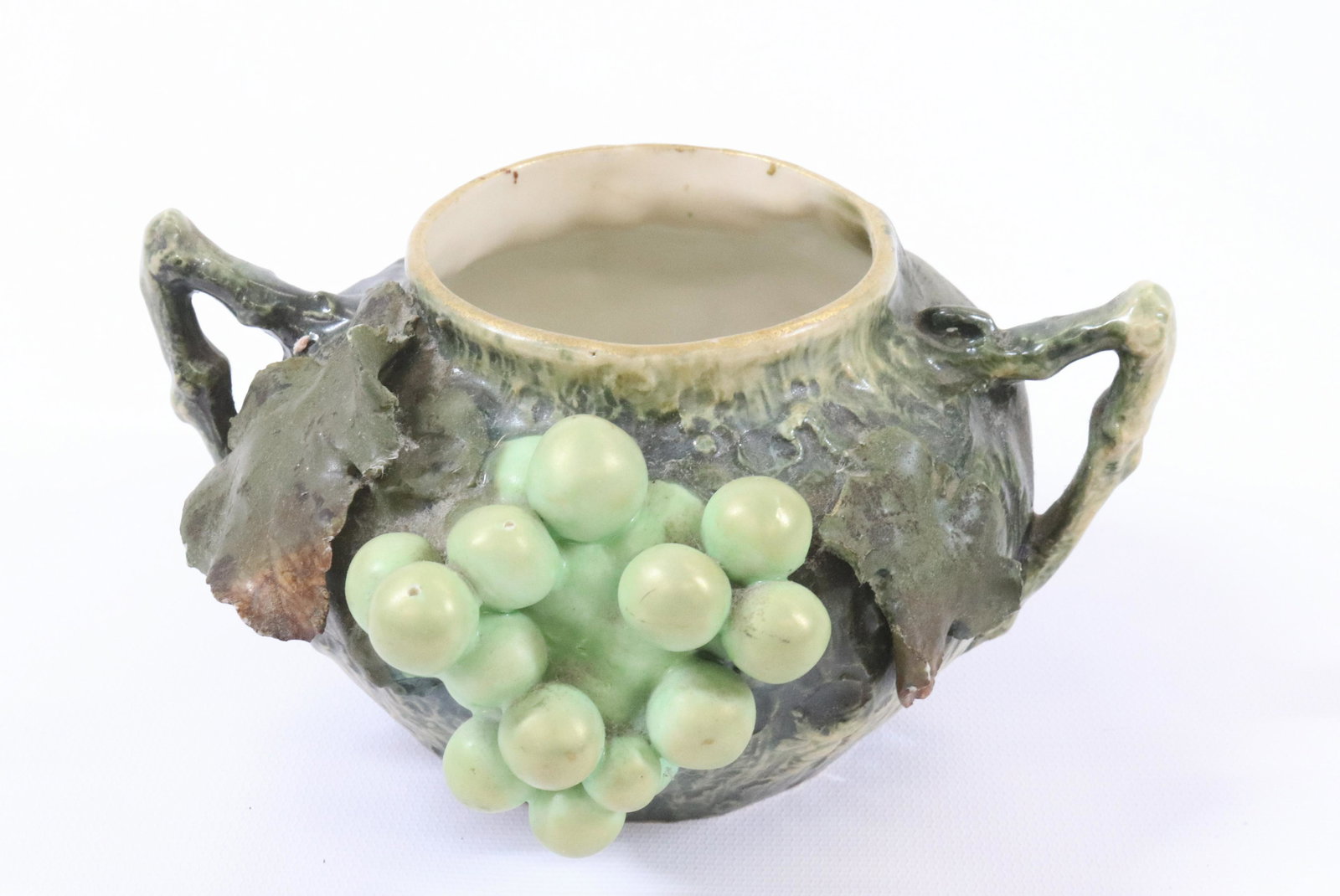 AMPHORA AUSTRIA BOWL: WITH TWO HANDLES AND IRIDESCENT WHITE GRAPES AND LEAVES DIMENSIONS: 3 1/4"H X 6" DIA TERMS: Hartzell's Auction Gallery will handle most of the shipping in-house. WE do reserve the right to not ship so
