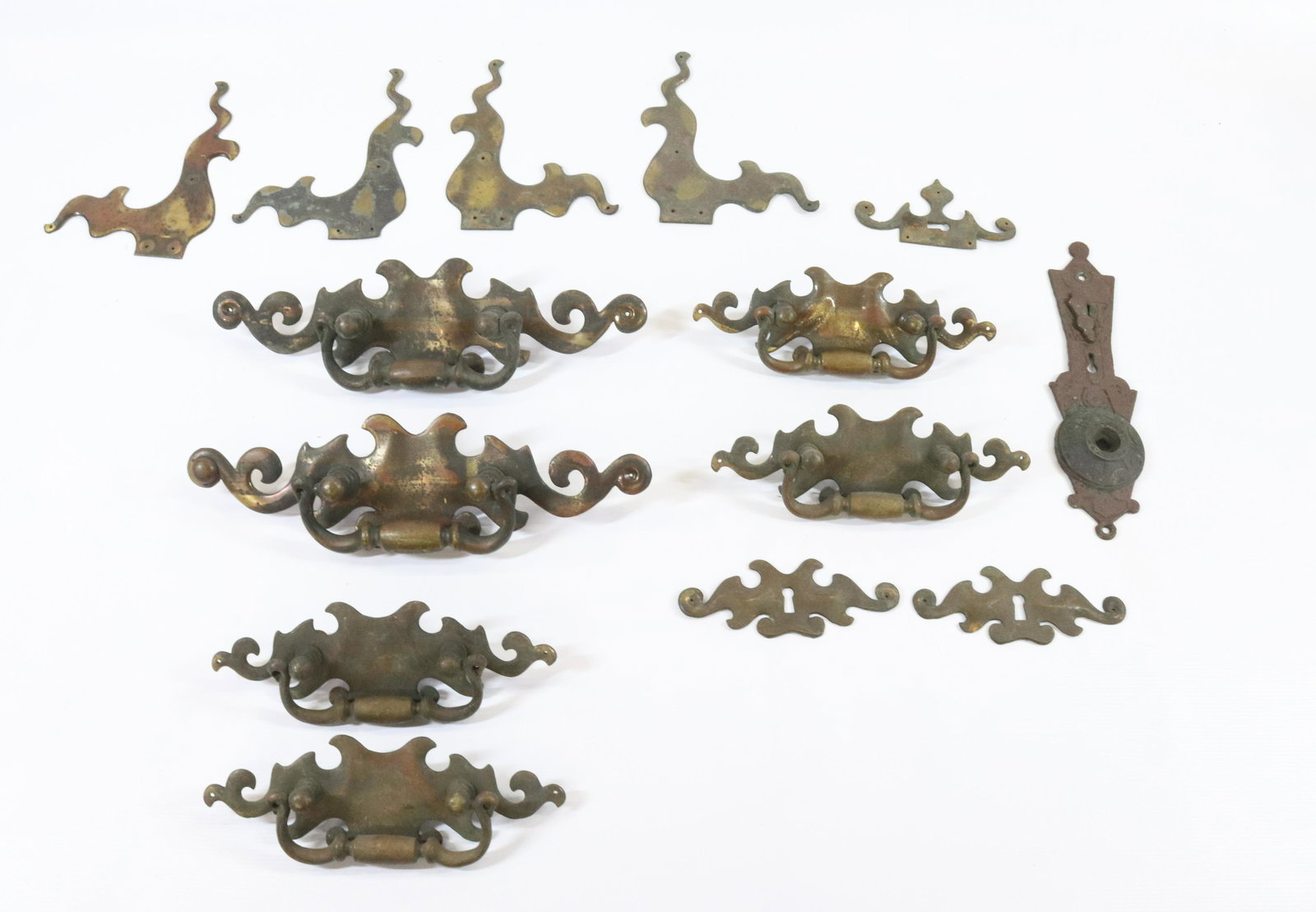 BRONZE ART NOUVEAU DRAWER PULLS: (13) INCLUDING TWO LARGE PULLS FOUR SMALLER PULLS FOUR CORNER BRACKETS AND THREE KEY ESCUTCHEONS DIMENSIONS: LARGE PULLS 11 3/4"L SMALLER 8 1/4" L TERMS: Hartzell's Auction Gallery will handle most of