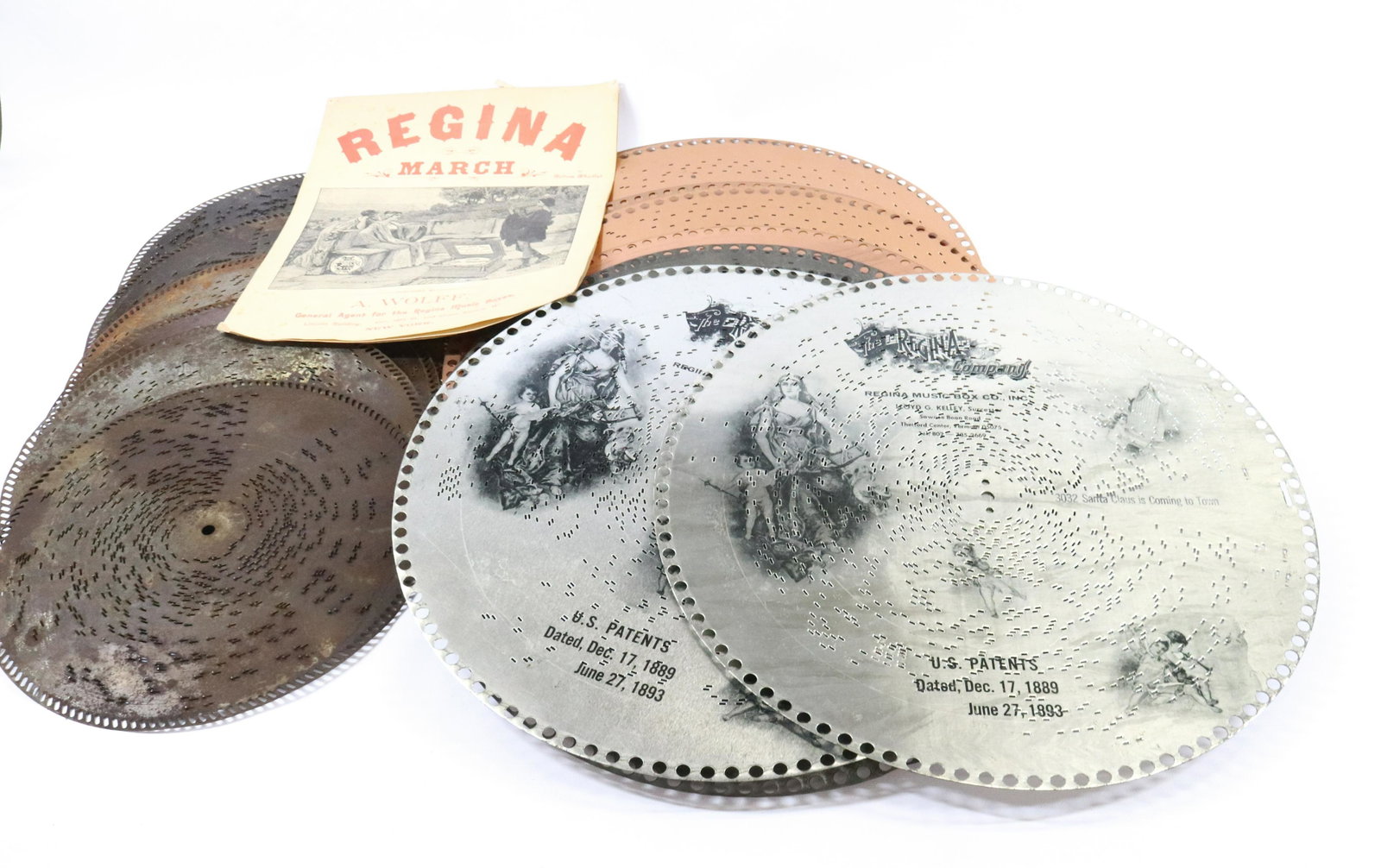 MUSIC BOX DISCS: INCLUDES (17) 15 1/2"DISC AND (6) 11" DISC WITH THE REGINA MARCH MUSIC DIMENSIONS: 15 1/2" 11" TERMS: Hartzell's Auction Gallery will handle most of the shipping in-house. WE do reserve the right to n