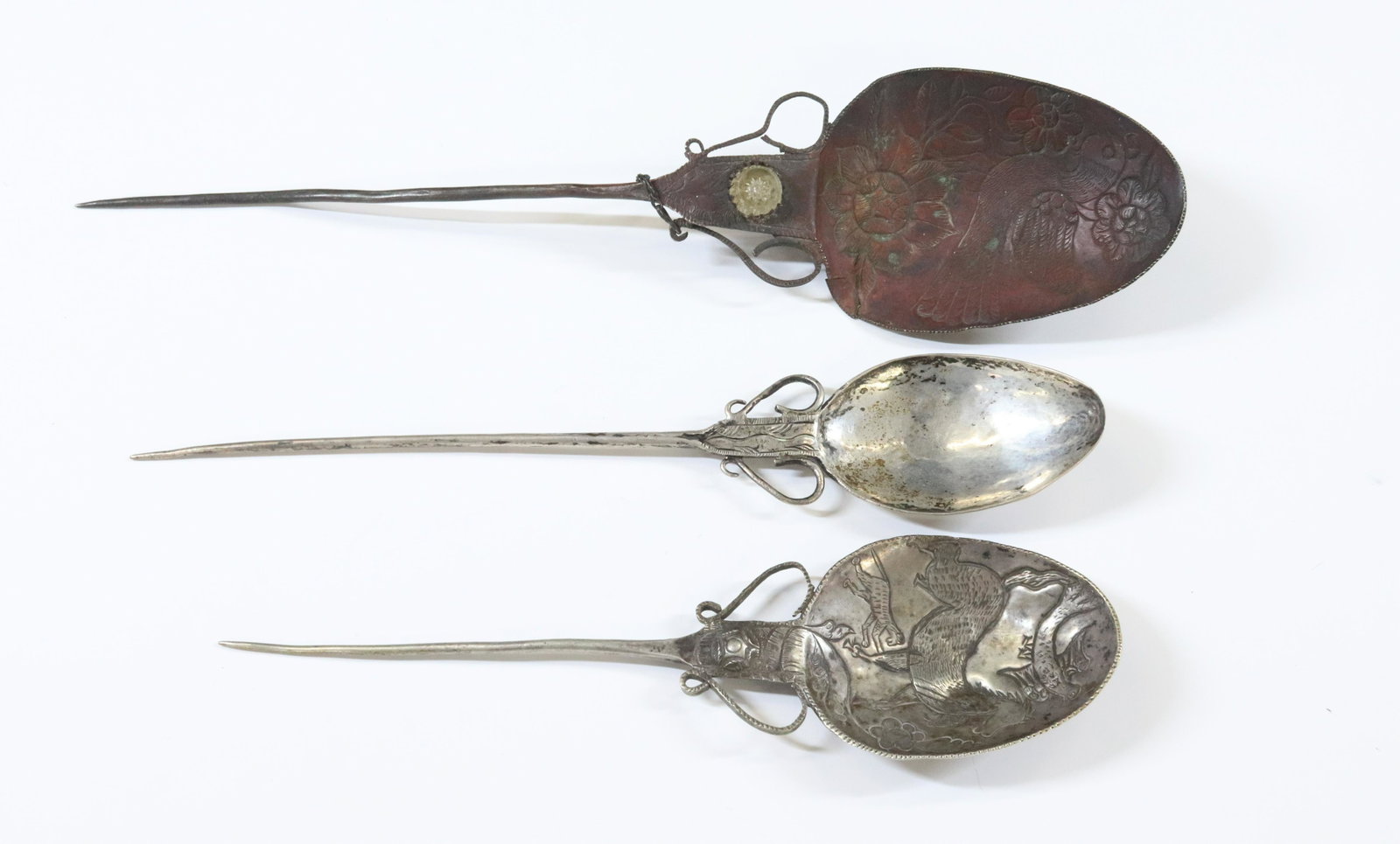 SILVER HAND WROUGHT SPOONS: (3)TWO HAND CHASED ONE WITH HORSE ALL HAVE RAT TAIL HANDLES POSSIBLY NORTH INDIA TOTAL WEIGHT 5.9 OZT SILVER GRADE 800 TO 900 DIMENSIONS: 13"L 10 3/4"L 9 1/4"L TERMS: Hartzell's Auction Gallery will h