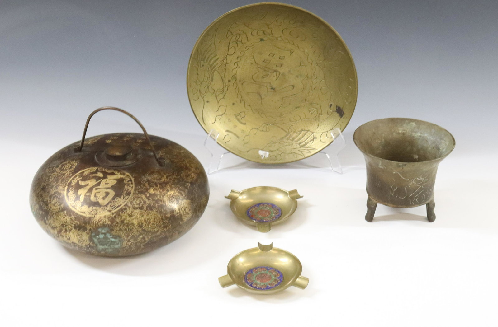 CHINESE BRASS GROUPING: (5) INCLUDING DECORATED WATER CANTEEN, BOWL AND FLOWER POT TWO ASHTRAYS WITH ENAMEL DIMENSIONS: CANTEEN 3 1/2"H X 7 1/2" TERMS: Hartzell's Auction Gallery will handle most of the shipping in-house. WE