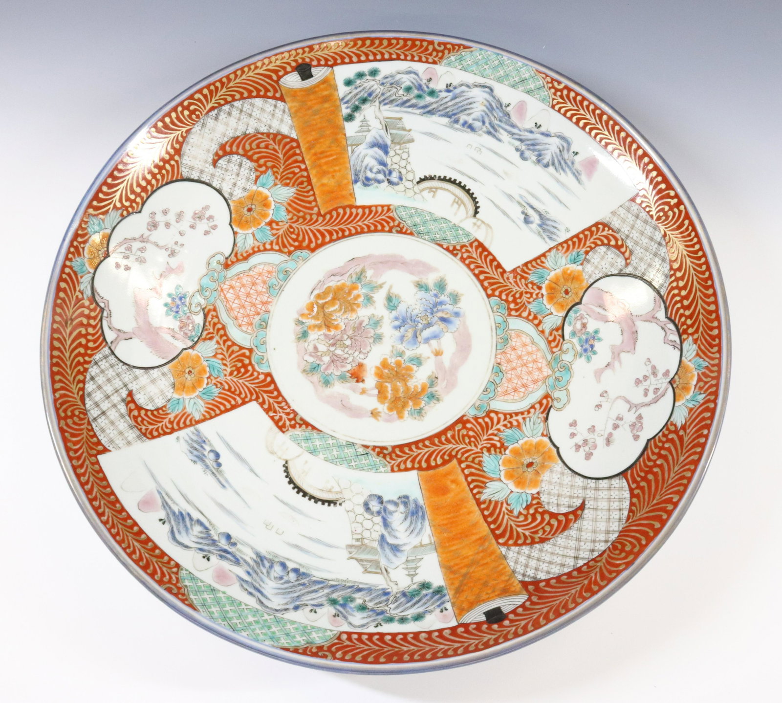 IMARI CHARGER: RED BACKGROUND WITH TWO SCENES APPEAR ON SCROLLS GOLD HIGHLIGHTS AND FOLDING STAND DIMENSIONS: 3 1/4"H X 18 1/4" TERMS: Hartzell's Auction Gallery will handle most of the shipping in-house. WE do rese
