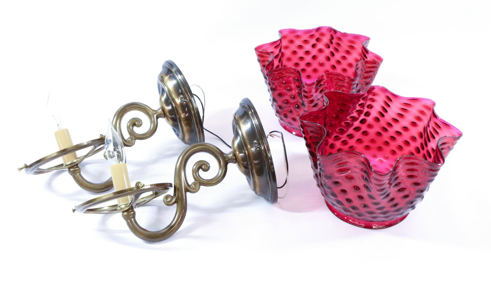 CRANBERRY GLASS WALL SCONCES: (2) ANTIQUE HOBNAIL WITH RUFFLED RIMS GAS SHADES AND CONTEMPORARY SOLID BRASS FIXTURES DIMENSIONS: 8"H X 11" TERMS: Hartzell's Auction Gallery will handle most of the shipping in-house. WE do reserve 