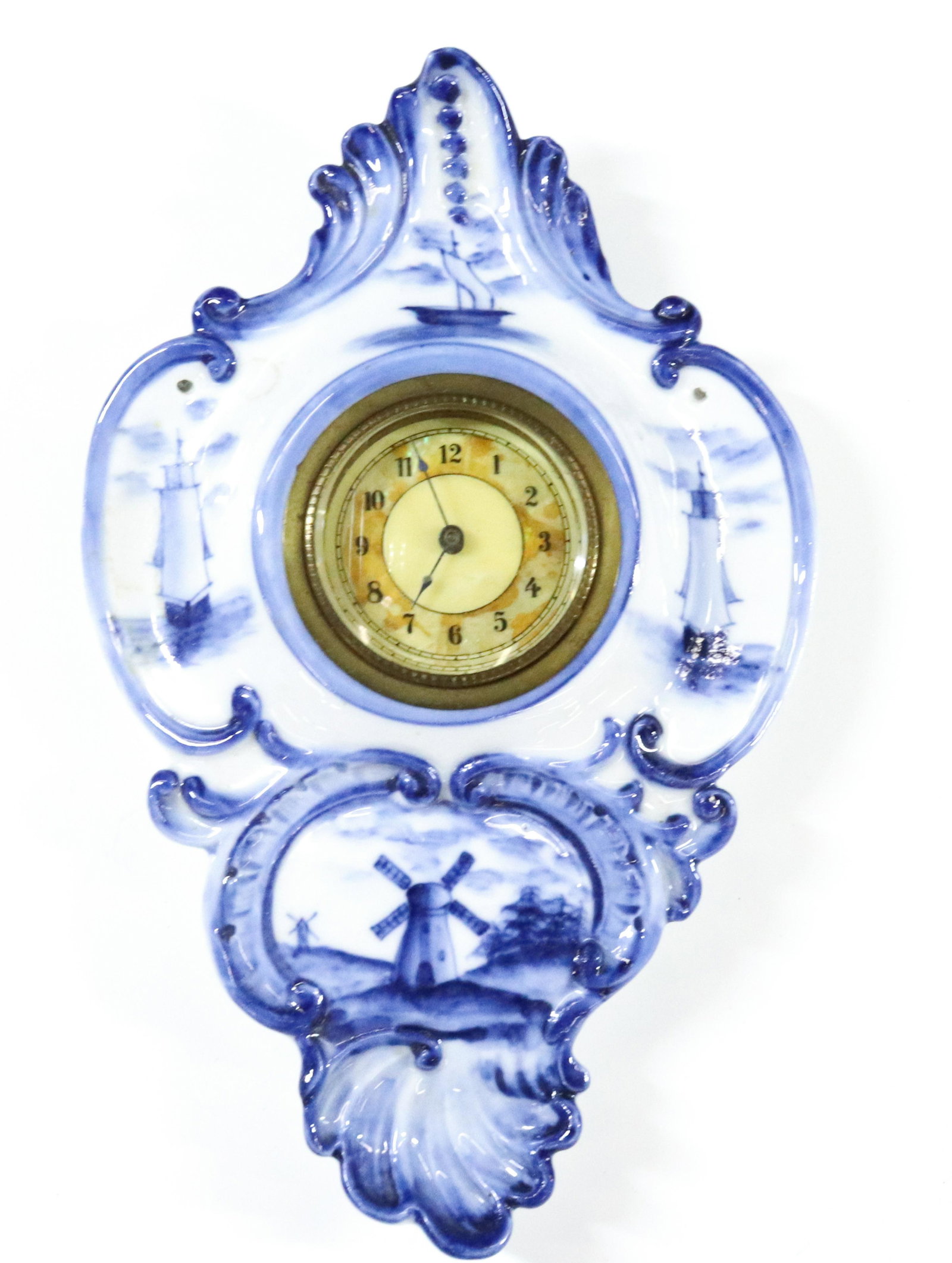DELFT PORCELAIN WALL CLOCK: WIND UP BEVELED GLASS LENS HAND PAINTED UNDERGLAZE BLUE 1920 DIMENSIONS: 9 1/4"H X 6" TERMS: Hartzell's Auction Gallery will handle most of the shipping in-house. WE do reserve the right to not ship s