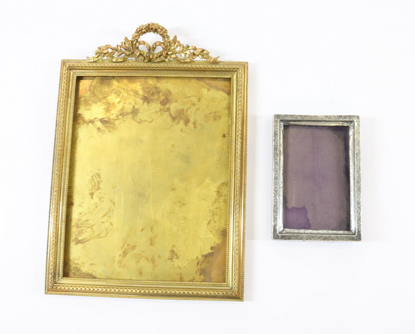 BRONZE AND STERLING PICTURE FRAMES: STERLING WITH ENGRAVED FLORAL BORDER ORIGINAL BACK AND STAND BRONZE FRAME STERN BROTHERS. NEW YORK FRANCE ORIGINAL BACK AND STAND DIMENSIONS: 5 1/2"H X 3 3/4" 12"H X 8 1/2" TERMS: Hartzell's Auction G