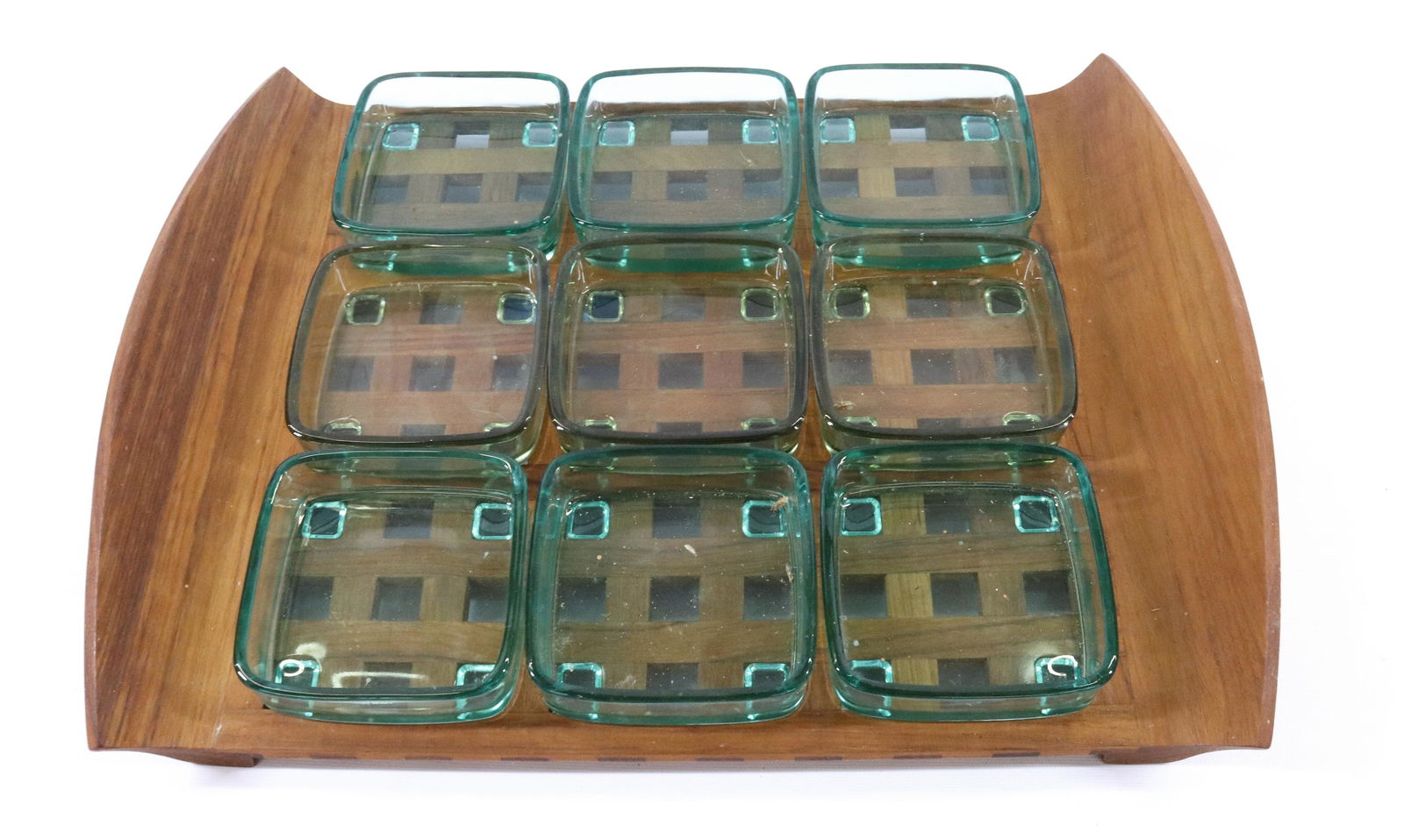 JENS QUISTGAARD DANSK TEAK/GLASS SERVING TRAY: LATTICE WORK SERVING TRAY WITH NINE GLASS INSERTS (THREE DIFFERENT COLOR GREEN). TRAY MRKD. ON BOTTOM. DIMENSIONS: 18 1/2" X 13 1/2" TERMS: Hartzell's Auction Gallery will handle most of the shipping