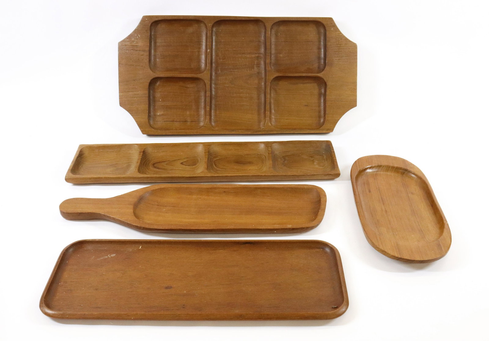 GROUP LOT OF DANISH MODERN TRAYS: (5) TEAK TRAYS. ARISTACRAFT, DIGSMED DENMARK AND MORE DIMENSIONS: LONGEST 20" TERMS: Hartzell's Auction Gallery will handle most of the shipping in-house. WE do reserve the right to not ship some larg