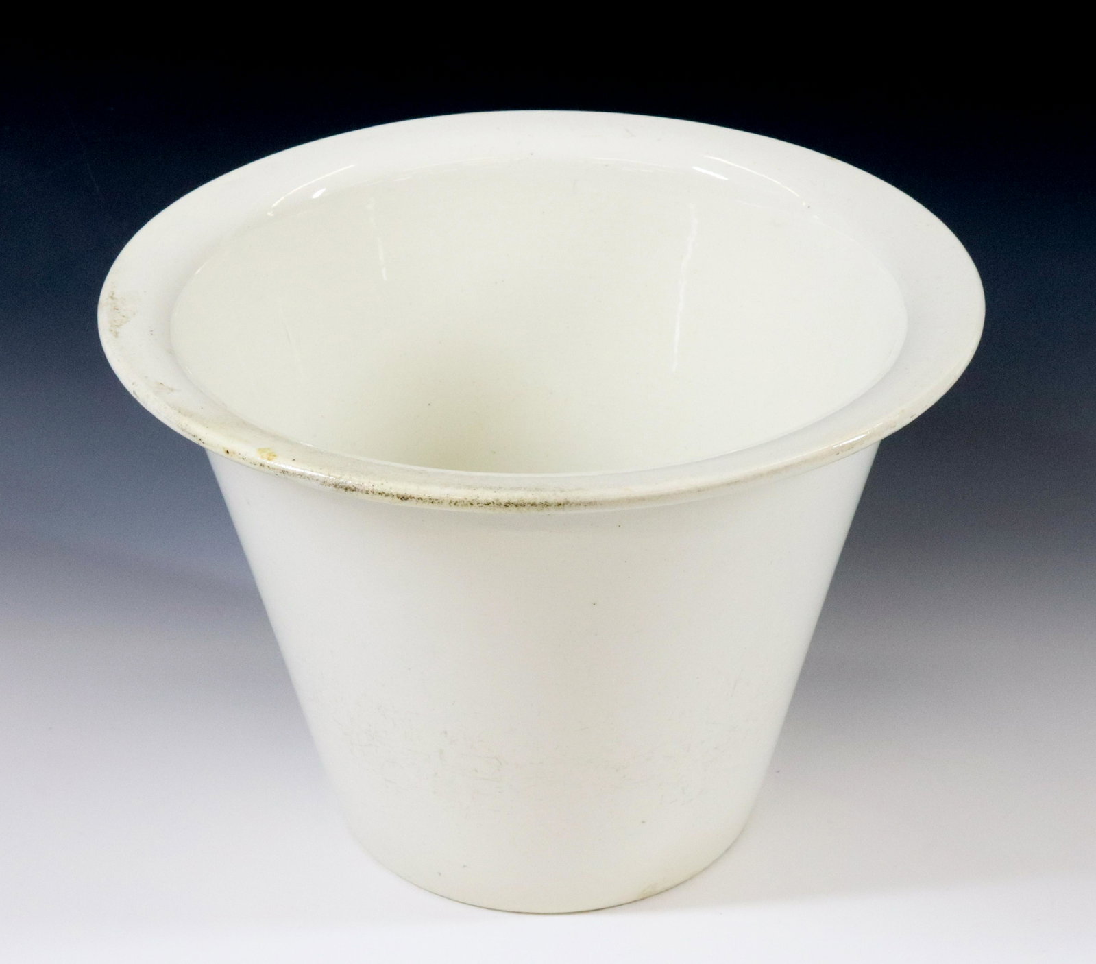 UNUSUAL SHAPED IRONSTONE VESSEL: CANTED SIDES WITH FLARED TOP LIP. STAMPED ON BOTTOM Size: 8" X 11" Terms: Hartzell's Auction Gallery will handle most of the shipping in-house. WE do reserve the right to not ship some large items, la