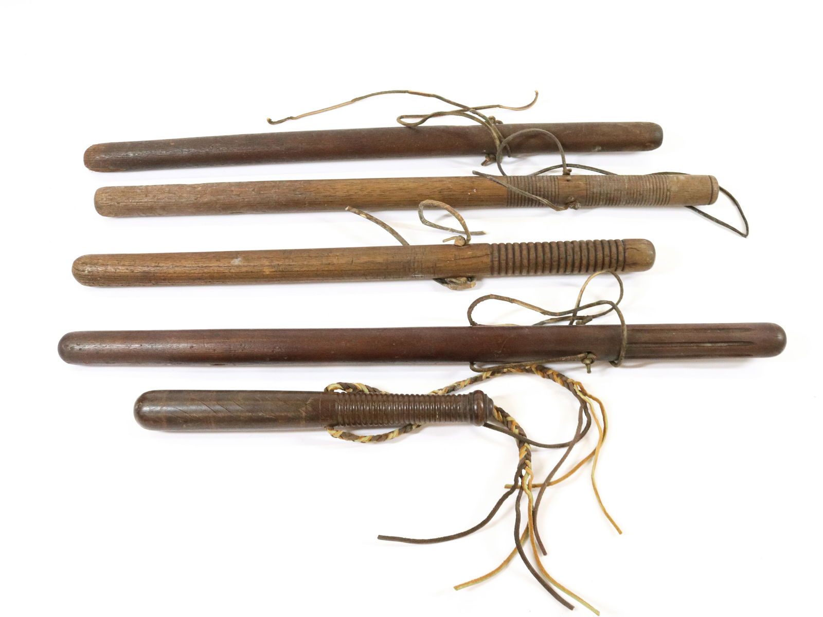 (5) WOODEN BILLY CLUBS OR NIGHTSTICKS: TURNED HARDWOOD WITH LEATHER STRAPS. VARIOUS SIZES AND TURNINGS Size: 12" TO 26" L Terms: Hartzell's Auction Gallery will handle most of the shipping in-house. WE do reserve the right to not ship some