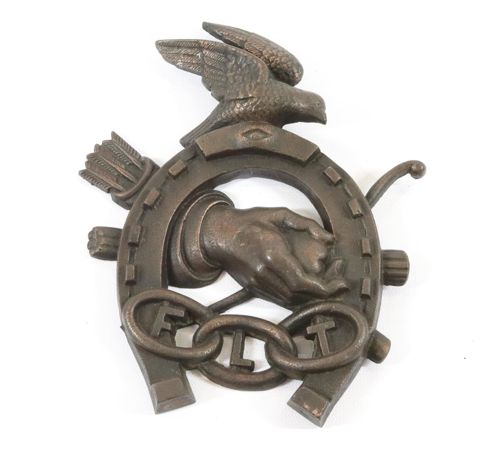 CAST IRON ODDFELLOWS PLAQUE: HORSESHOE PLAQUE WITH EAGLE AND "FLT" INITIALS IN CHAIN WITH SHAKING HANDS AND ARROWS Size: 7" X 6" Terms: Hartzell's Auction Gallery will handle most of the shipping in-house. WE do reserve the right