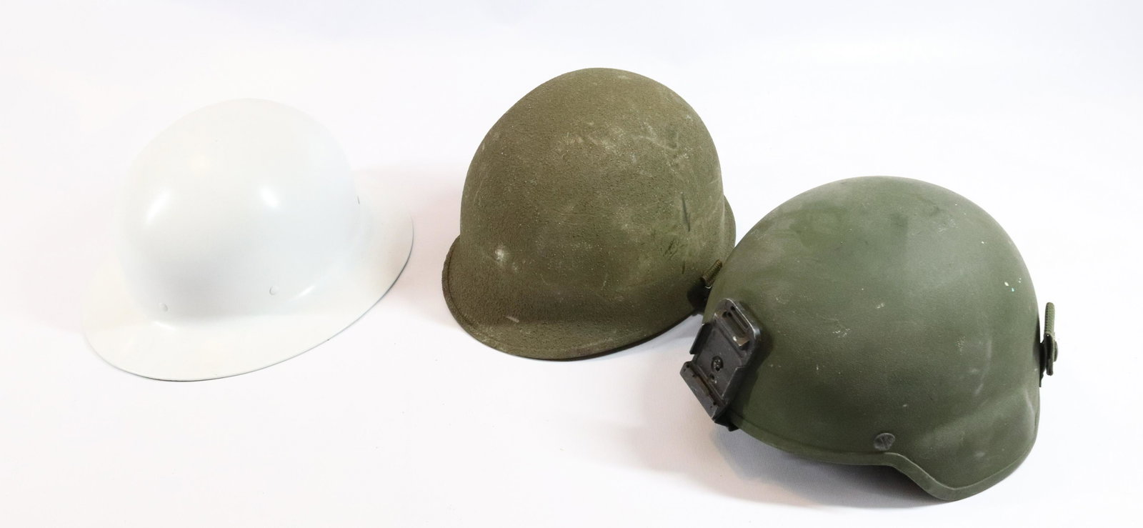 LOT OF MILITARY HELMETS: (3) HELMETS - (2) GREEN ARMY STYLE HELMETS, (1) WHITE HELMET Terms: Hartzell’s Auction Gallery will handle all Background Checks On-Site. Sunday April 3rd from 9:00am till 2:00pm or Monday April