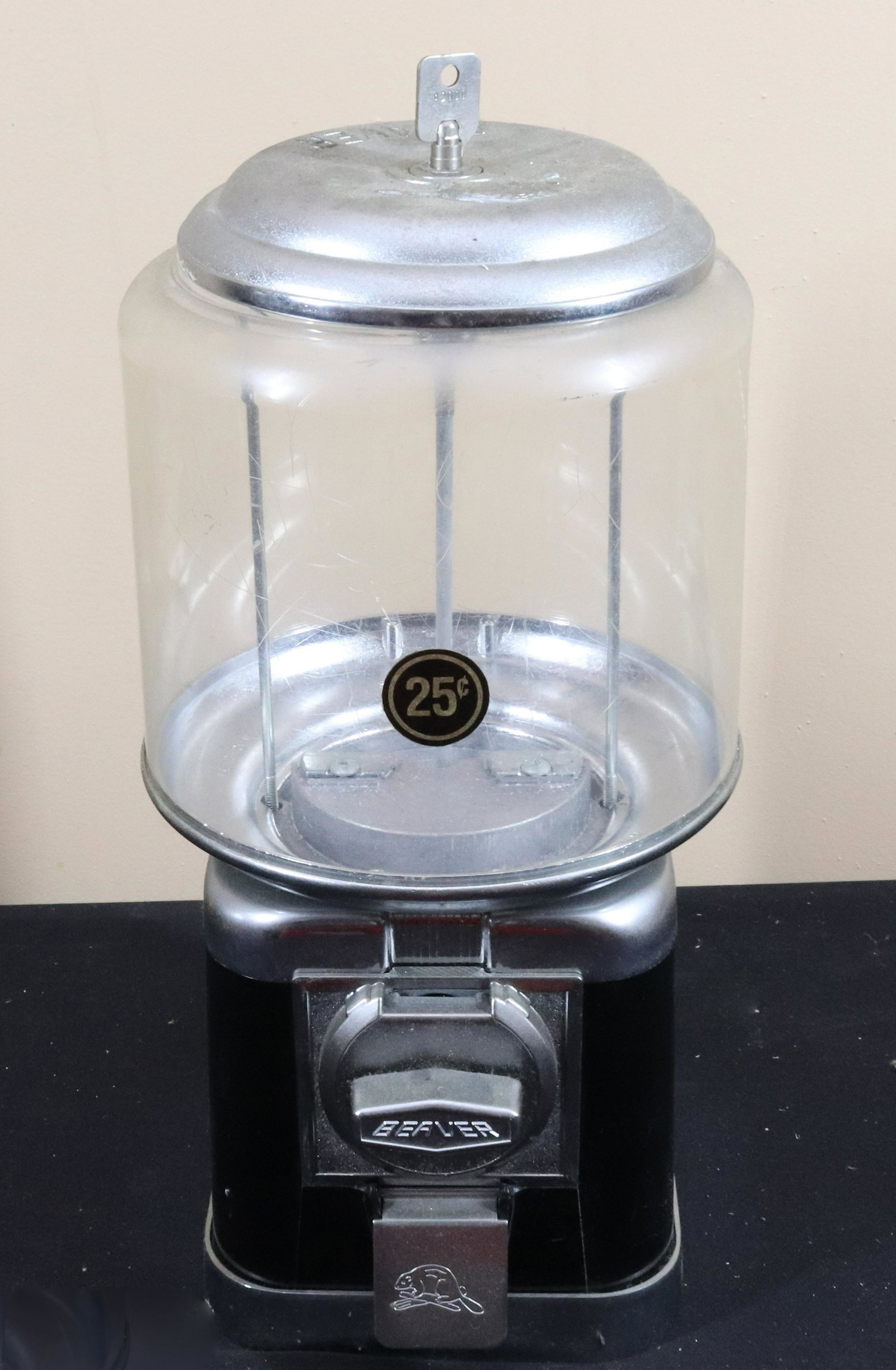 VINTAGE GUMBALL MACHINE: BEAVER BRAND VENDING MACHINE - 25 CENT MACHINE WITH KEY Size: 16" H Terms: This is an On-Site Auction. Pick-up will be from Monday April 4th – Thursday April 7th from 9:00am till 4:00pm OR BY AP