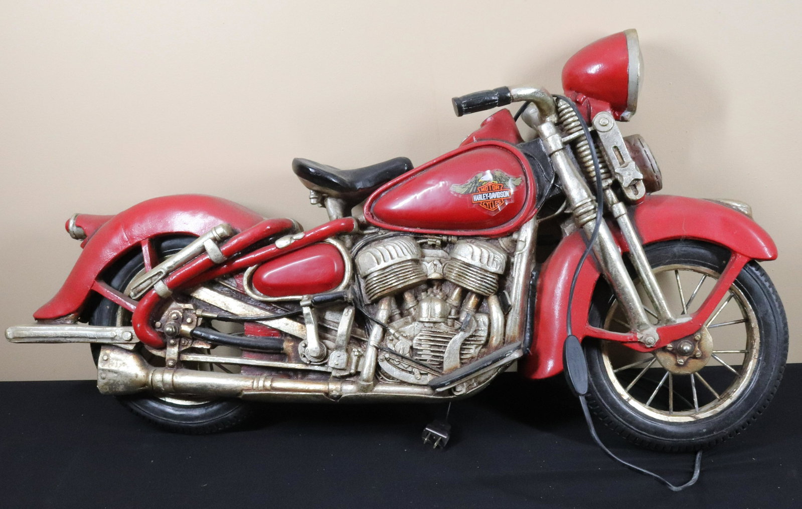 HARLEY DAVIDSON STYLE WALL LIGHT: ELECTRIC HARLEY MOLDED BIKE - COMPOSITION Size: 34" L Terms: This is an On-Site Auction. Pick-up will be from Monday April 4th – Thursday April 7th from 9:00am till 4:00pm OR BY APPOINTMENT. All