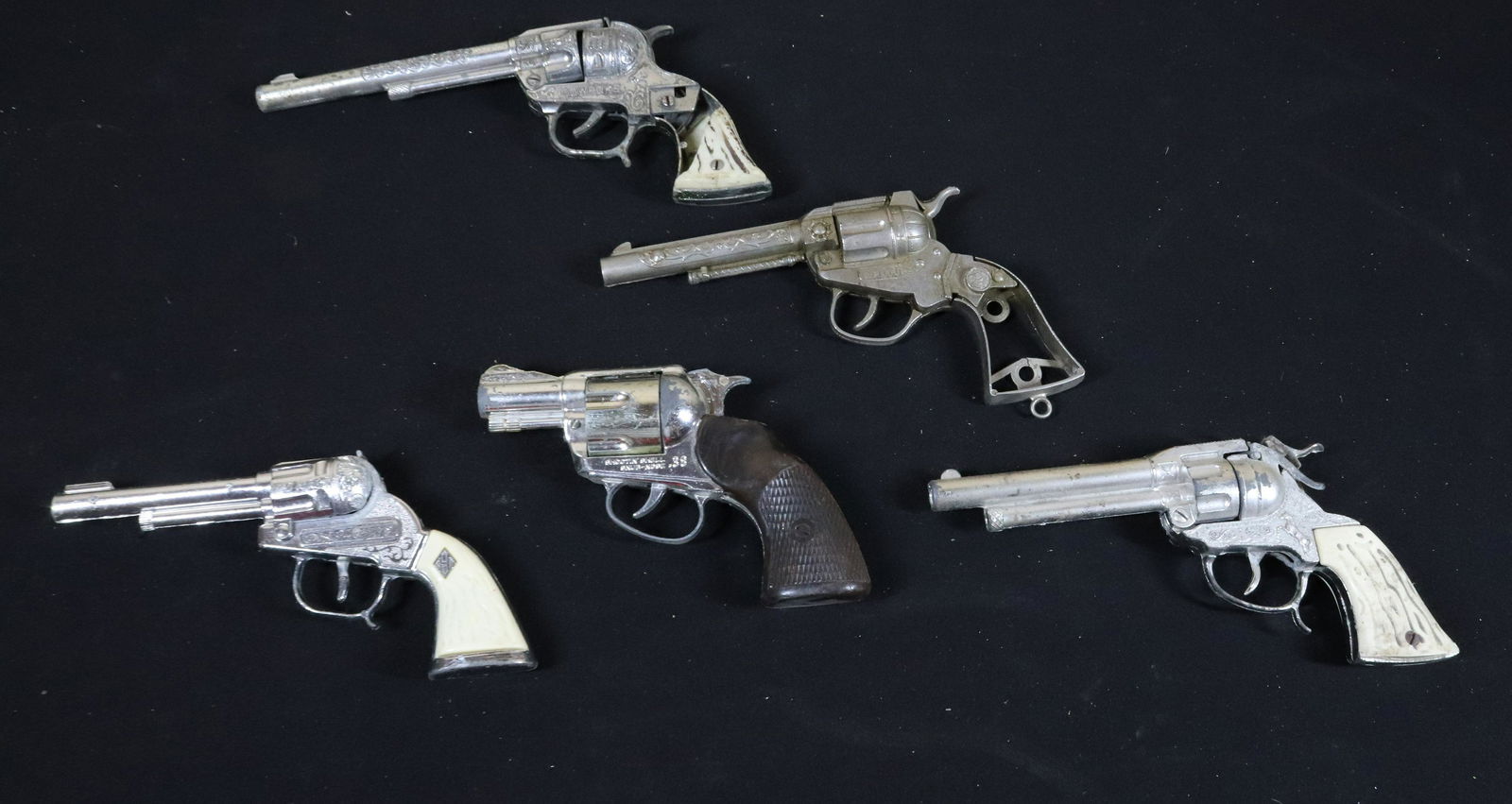 GROUP LOT OF VINTAGE CAP GUNS: (5) CAP GUNS - ONE MARKED COWPOKE, SPITFIRE, AND SNUB NOSE Terms: This is an On-Site Auction. Pick-up will be from Monday April 4th – Thursday April 7th from 9:00am till 4:00pm OR BY APPOINTMENT