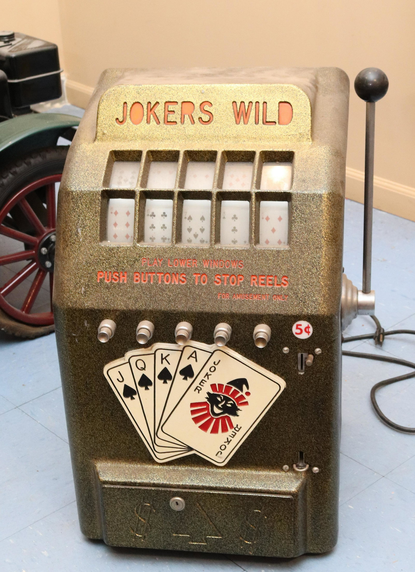 VINTAGE 1950S JOKER'S WILD ELECTRIC SLOT MACHINE: PAINTED ALUMINUM FRONT WITH MOLDED HEAVY PLASTIC BACK. LIGHTS. REELS DO NOT SPIN Size: 25" X 15" X 16" Terms: This is an On-Site Auction. Pick-up will be from Monday April 4th – Thursday April 7