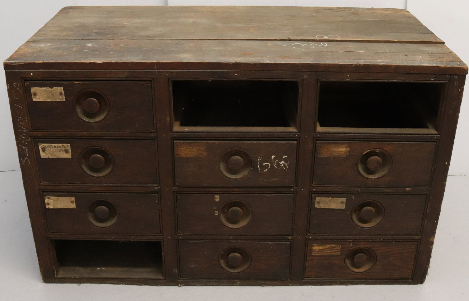 WOODEN STORAGE CABINET: 12 SECTION WITH 9 DRAWERS (MISSING 3) DIMENSIONS: 24" X 39 1/2" X 20 1/2" TERMS: Hartzell's Auction Gallery will handle most of the shipping in-house. WE do reserve the right to not ship some large it