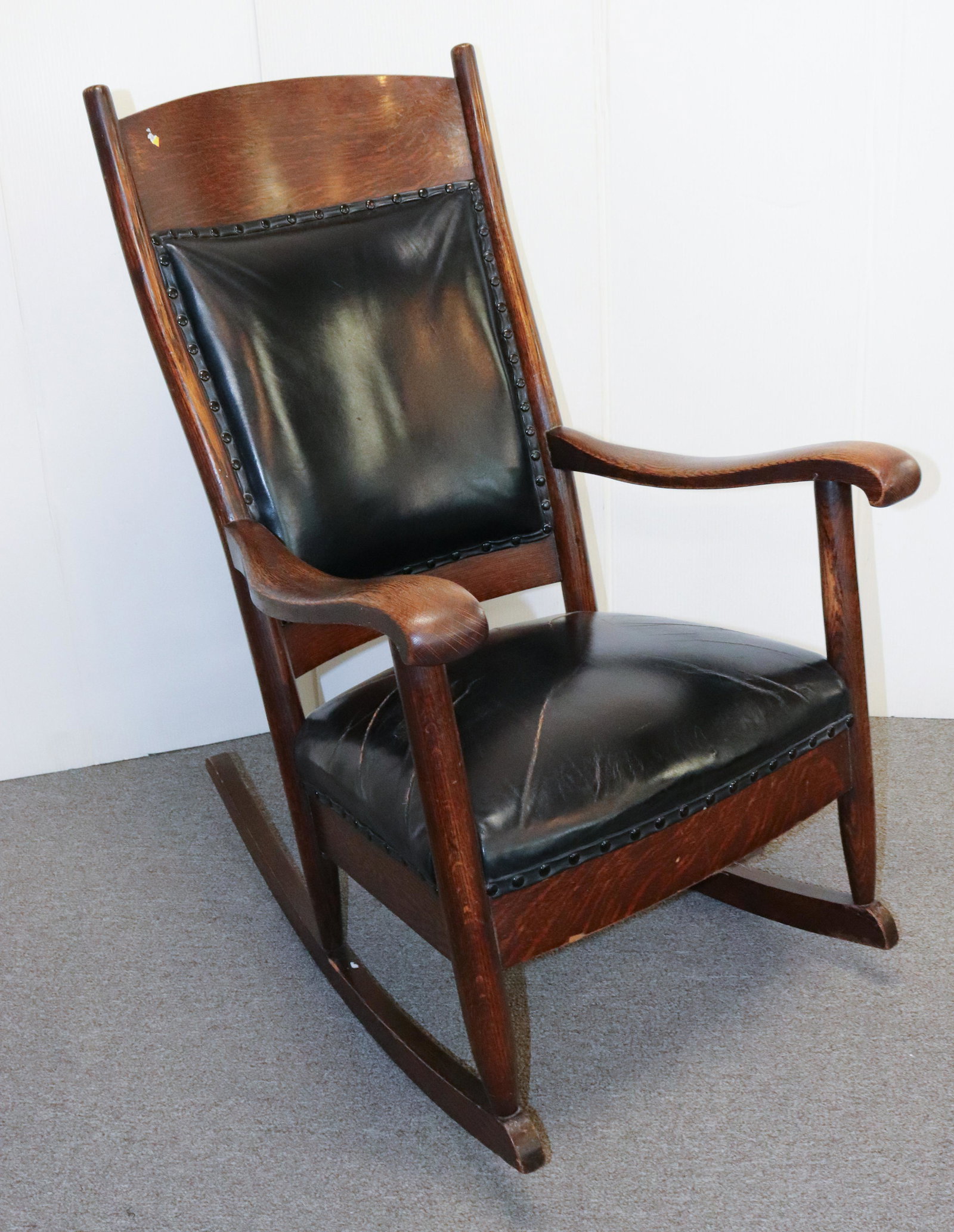 OAK ROCKING CHAIR: BLACK UPHOLSTERED BACK AND SEAT SIZE: 40" X 25" X 20" TERMS: Please Read Carefully. Pick-Up will be 1 WEEK ONLY. June 20th through June 24th. Hartzell’s Auction Gallery will Handle All Shipping 