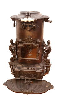 CHOUBERSKY CAST IRON STOVE: FRENCH STOVE. HEAVILY DECORATED WITH TRAY. ANGELS ON BOTH SIDES. WHEELED BODY. SOCIETY OF CHOUBERSKY 20 B. MONTMARIRE, PARIS 29" H
