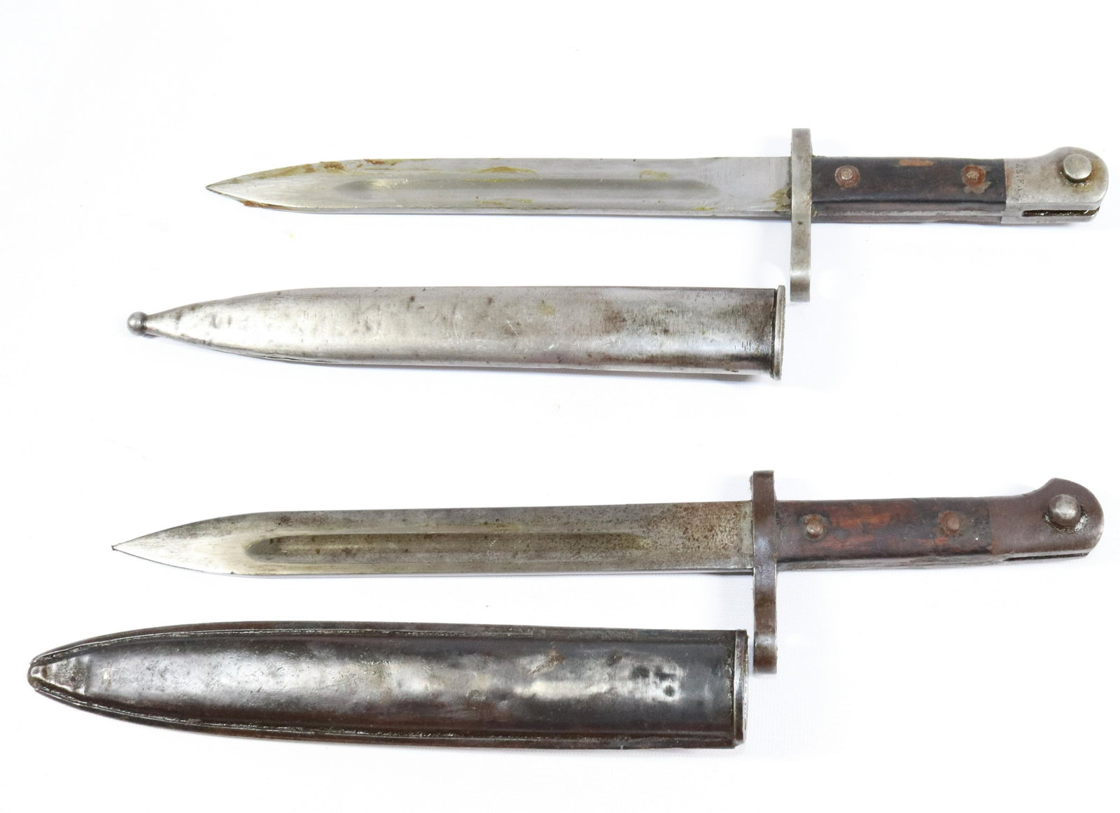 (2) VINTAGE MILITARY BAYONET KNIVES WITH SCABBARDS: GERMAN MAUSERS BAYONETS. ONE MRKD. AS.FA, #95641 AND OTHER #5087 Size: BLADES 9 3/4" L Terms: PLEASE READ THIS CAREFULLY AND FULLY BEFORE BIDDING - THIS IS AN ON-SITE AND LIVE IN PERSON AUCTION. PREVI