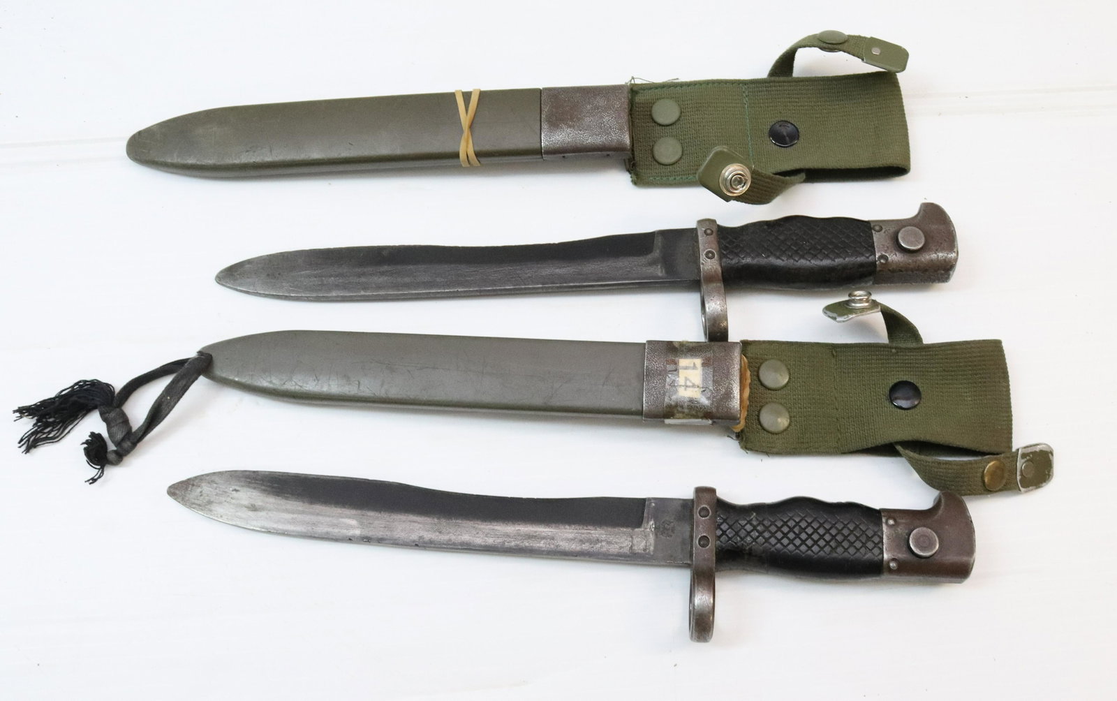 (2) VINTAGE MILITARY BAYONET KNIVES WITH SCABBARDS: ONE MRKD. E1 44137B "TOLEDO" WITH SYMBOL AND BIRD/CROWN ON OPPOSITE SIDE. OTHER IS MRKD. ET26617A "TOLEDO" AND BIRD/CROWN ON OPPOSITE SIDE Size: BLADE 8 1/2" L Terms: PLEASE READ THIS CAREFULLY AND FU