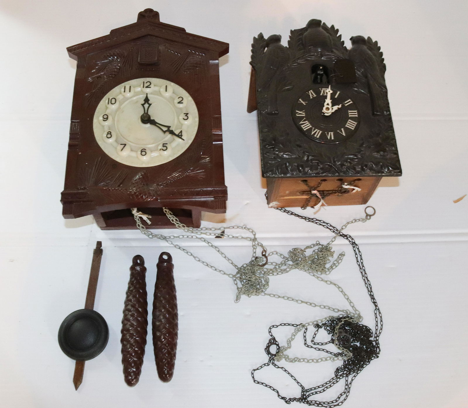 (2) VINTAGE CUCKOO CLOCKS: EMBOSSED PLASTIC STYLES Size: 9 1/2" AND 11 1/2" L Terms: PLEASE READ THIS CAREFULLY AND FULLY BEFORE BIDDING - THIS IS AN ON-SITE AND LIVE IN PERSON AUCTION. PREVIEW WILL BE SUNDAY JULY 10TH FROM 10: