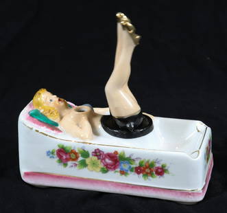 VINTAGE NAUGHTY NODDER ASHTRAY: PIN-UP GIRL WITH MOVING LEGS. SOUVENIR FROM "AQUARENA, SAN MARCOS". MEASURES 5 1/2" L. Terms & Conditions: Pick-up for this Auction will be Wednesday August 3rd and Thursday August 4th from 9:00am til