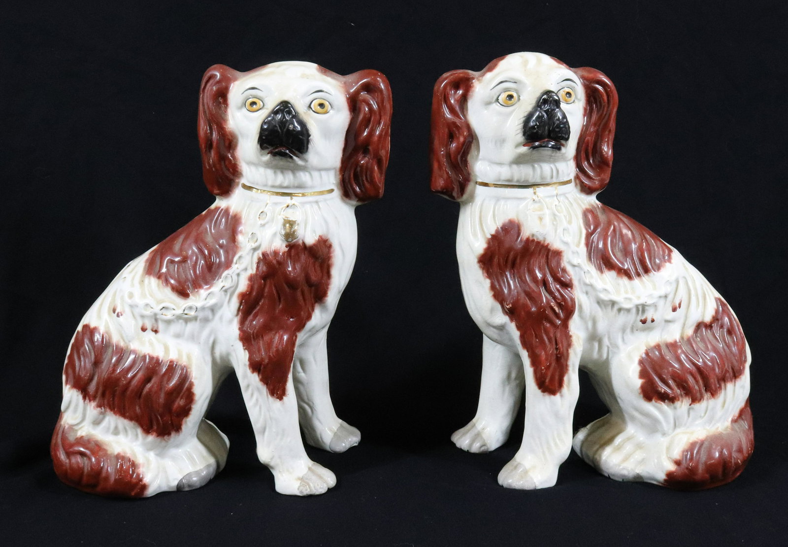PAIR OF STAFFORDSHIRE DOGS: PAINTED SPANIELS WITH GOLD CHAINS AND LOCKETS. STAMPED ON BOTTOM "ENGLAND". MEASURE 9 1/2" AND 9 3/4" H Terms & Conditions: Pick-up for this Auction will be Wednesday August 3rd and Thursday August 4t