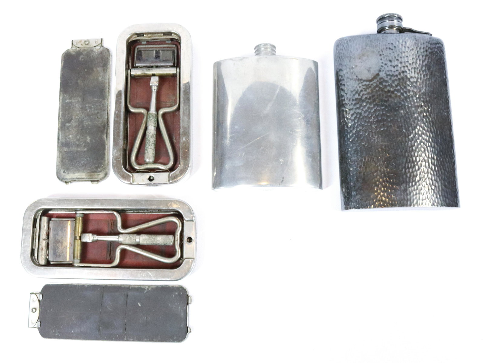 LOT OF FLASKS AND RAZORS: PEWTER AND SILVERPLATE FLASKS WITH TWO RAZOR KITS. LARGEST FLASK IS 7" L Terms & Conditions: Pick-up for this Auction will be Wednesday August 3rd and Thursday August 4th from 9:00am till 3:30pm and F