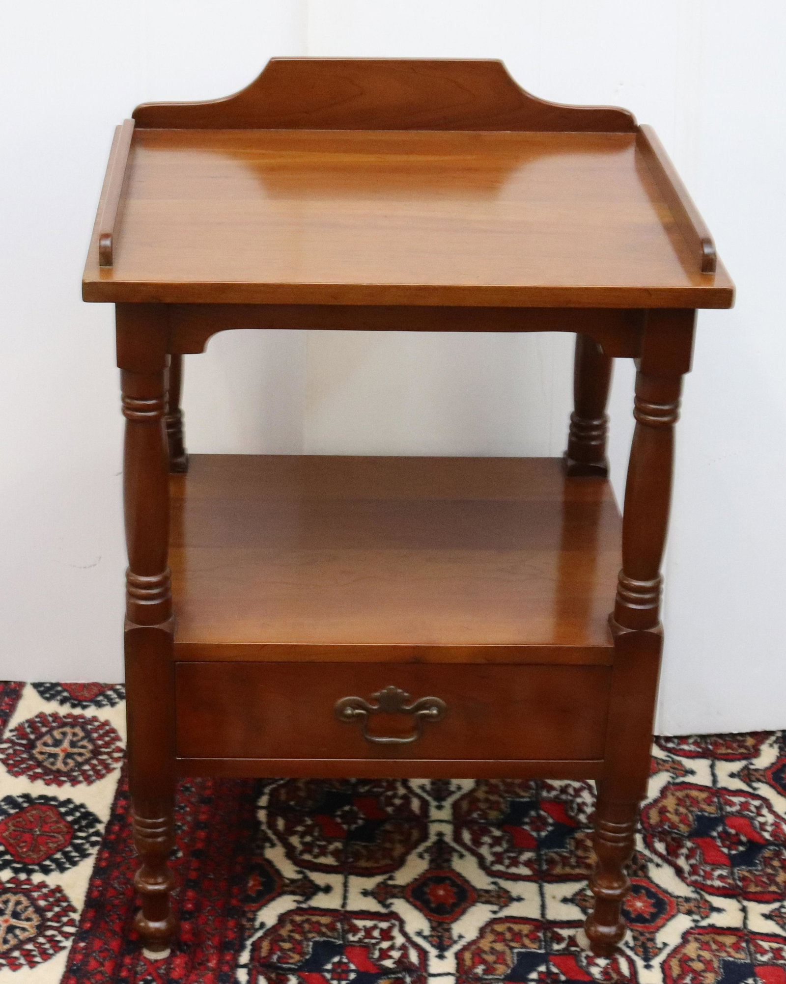 L & J G STICKLEY WASHSTAND: SOLID TOP OVER SHELF WITH SINGLE DRAWER BELOW. LABELED INSIDE OF DRAWER. MEASURES 30 1/2" X 21" X 17" Terms & Conditions: Pick-up for this Auction will be Wednesday August 3rd and Thursday August 4th