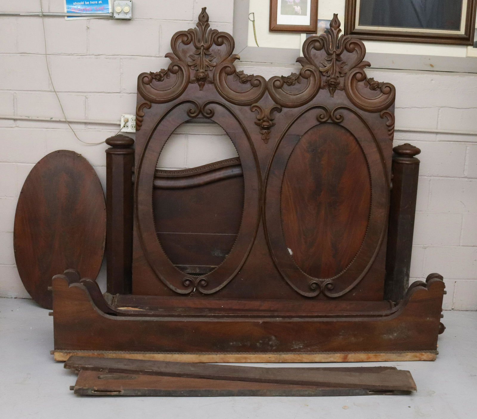 LARGE VICTORIAN BED: DOUBLE OVAL HEADBOARD WITH FLORAL CARVING AT TOP. OCTAGONAL CORNER POSTS. AS-FOUND CONDITION. HEADBOARD PANEL ON ITS OWN 70" X 58" Terms & Conditions: Pick-up for this Auction will be Wednesday August