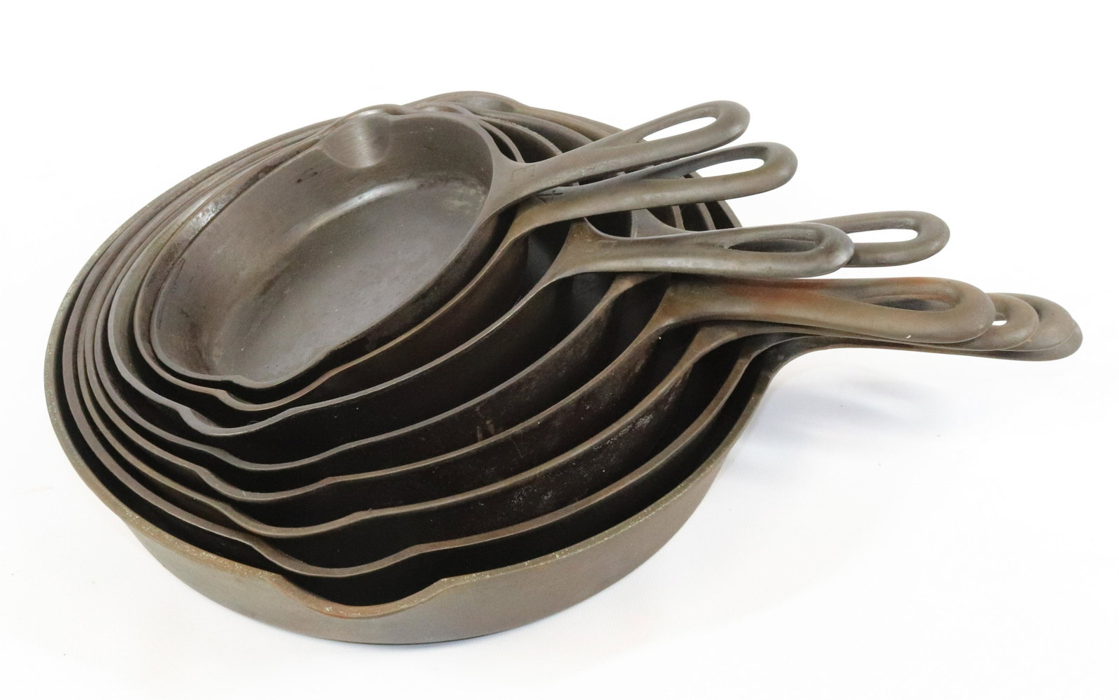 (8) GRISWOLD CAST IRON SKILLETS: INCLUDING: #3 (709B), #4 (702A), #5 (724), #6 (699D), #7 (701A), #8 (704), #9 (710F) AND #10 (716A). MEASURE 10 1/2" TO 16 3/4" TOTAL LENGTH.