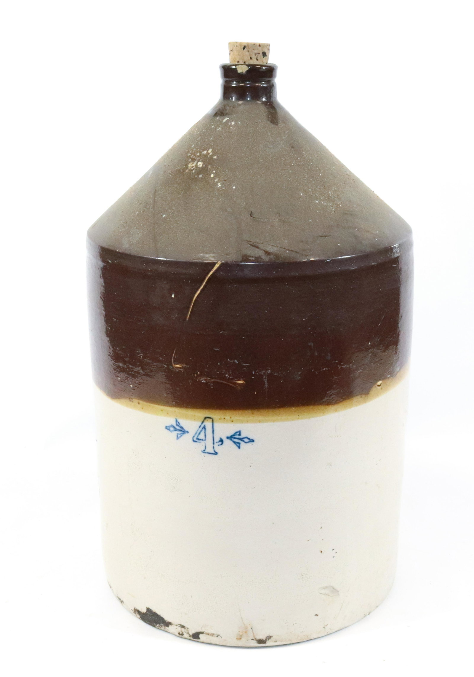 FOUR GALLON STONEWARE JUG: BROWN/WHITE GLAZE WITH BLUE #4. MEASURES 17 1/2" H.