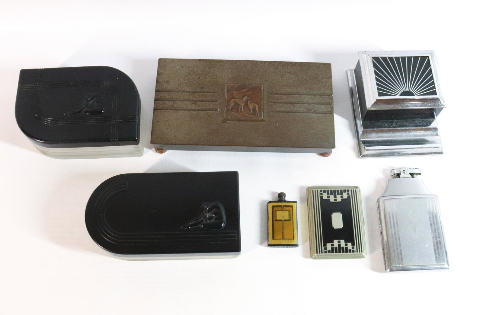 LOT OF ART DECO ACCESSORIES: INCLUDING: TWO HICKOK DRESSER LIDDED JARS (ONE LID METAL, ONE PLASTIC WITH NUDE MOTIF), TWO CIGARETTE BOXES, ENAMELED CIGARETTE CASE, MATCHKING STRIKER AND RONSON CIGARETTE LIGHTER/HOLDER. LIGHTER MEA